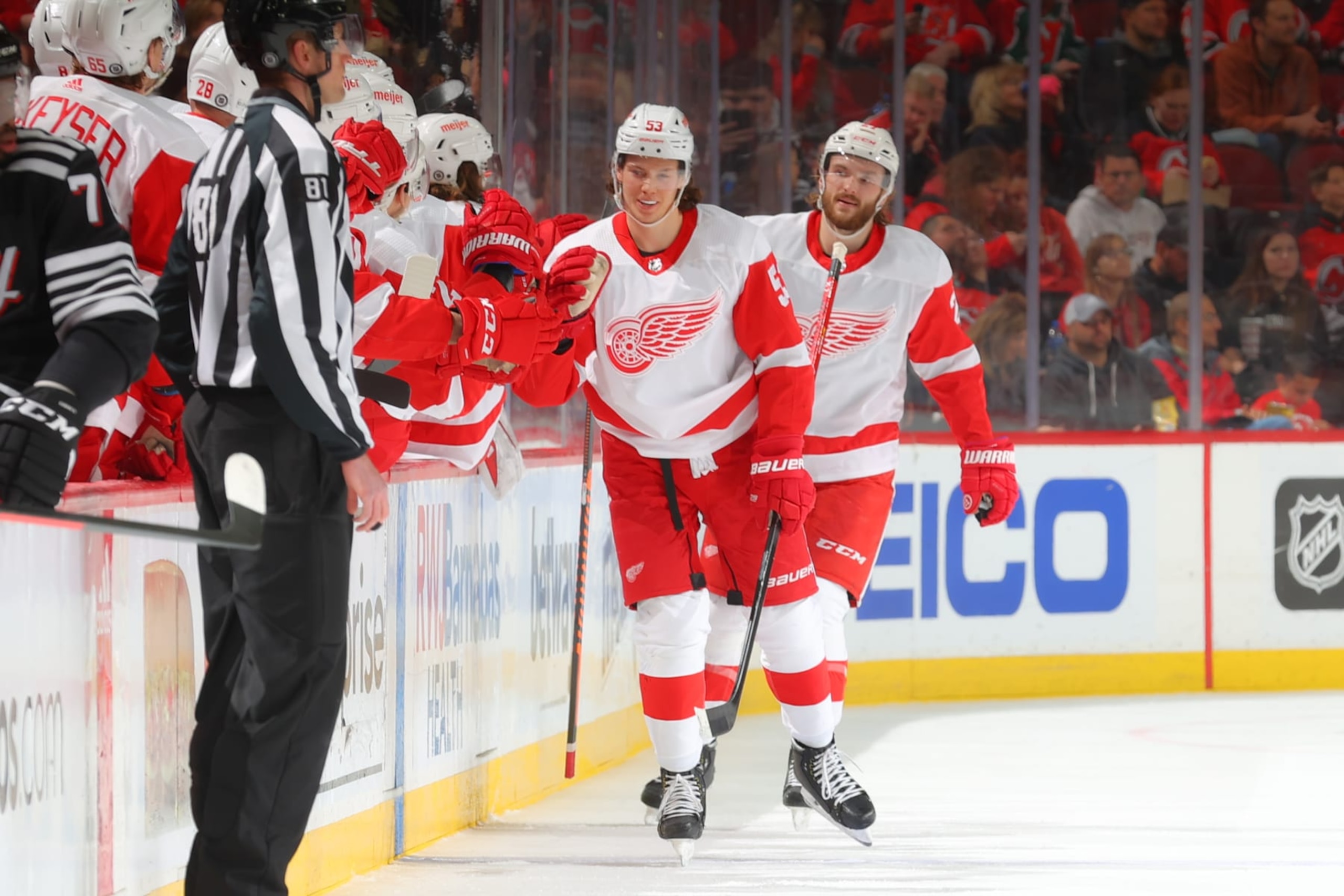 NEWARK, NJ - APRIL  29:   Moritz Seider #53 of the Detroit Red Wings celebrates at the bench after he scores against the New Jersey Devils on April 29, 2022 at the Prudential Center in Newark, New Jersey.  (Photo by Rich Graessle/Getty Images)
