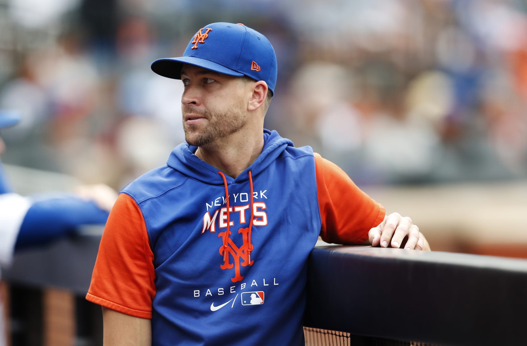 New York Mets pitcher Jacob deGrom ooks on in the dugout during the seventh inning of a baseball game against the Washington Nationals, Sunday, Sept. 4, 2022, in New York. (AP Photo/Noah K. Murray)