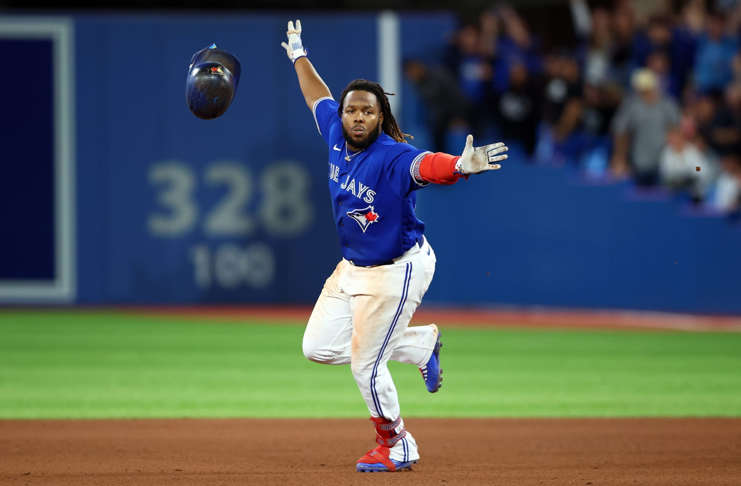 TORONTO, ON - SEPTEMBER 26:  Vladimir Guerrero Jr. #27 of the Toronto Blue Jays celebrates his walk-off RBI single in the tenth inning against the New York Yankees at Rogers Centre on September 26, 2022 in Toronto, Ontario, Canada.  (Photo by Vaughn Ridley/Getty Images)
