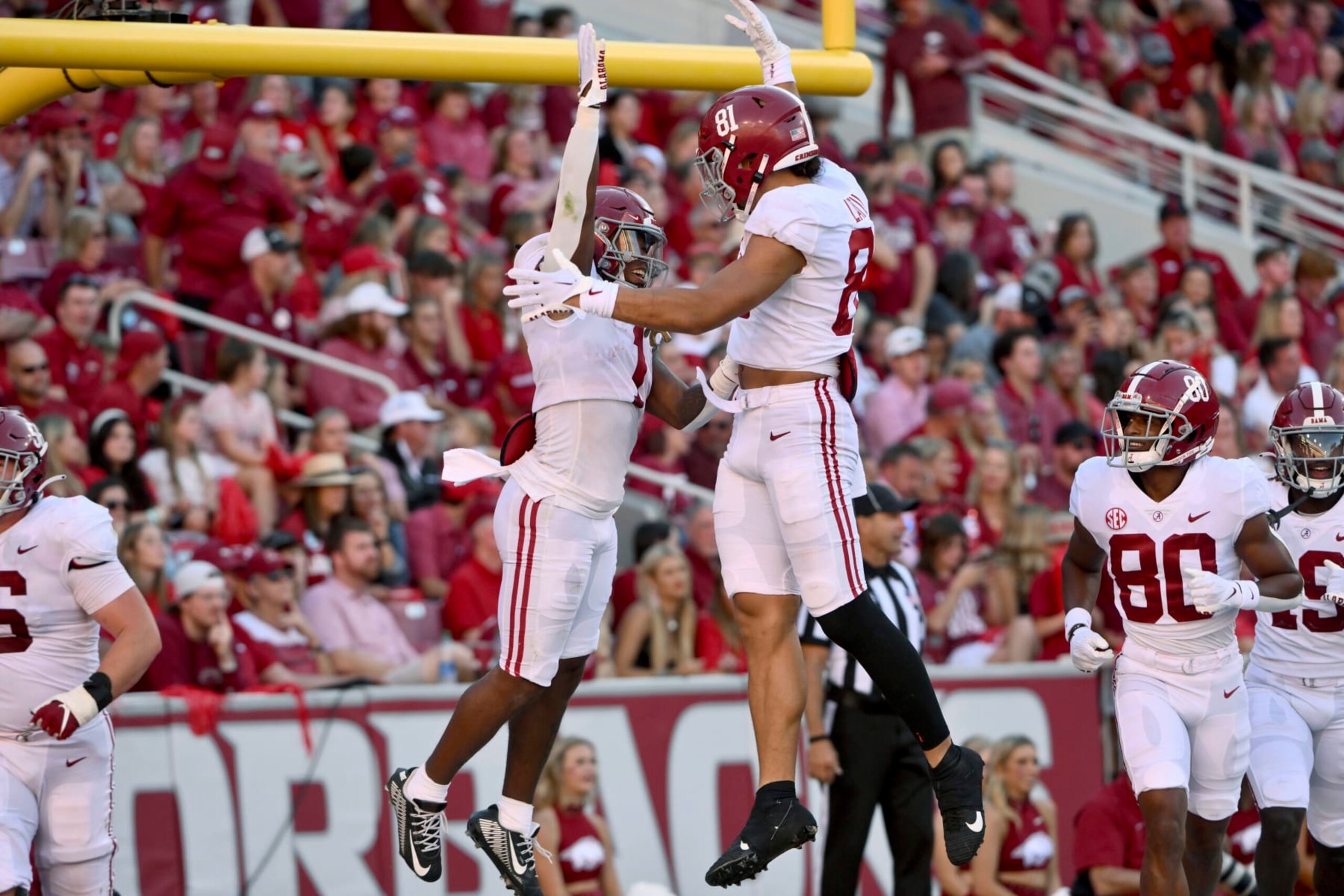 Alabama running back Jahmyr Gibbs (1) celebrates with tight end Cameron Latu (81) after scoring a touchdown against Arkansas during the second half of an NCAA college football game Saturday, Oct. 1, 2022, in Fayetteville, Ark. (AP Photo/Michael Woods)