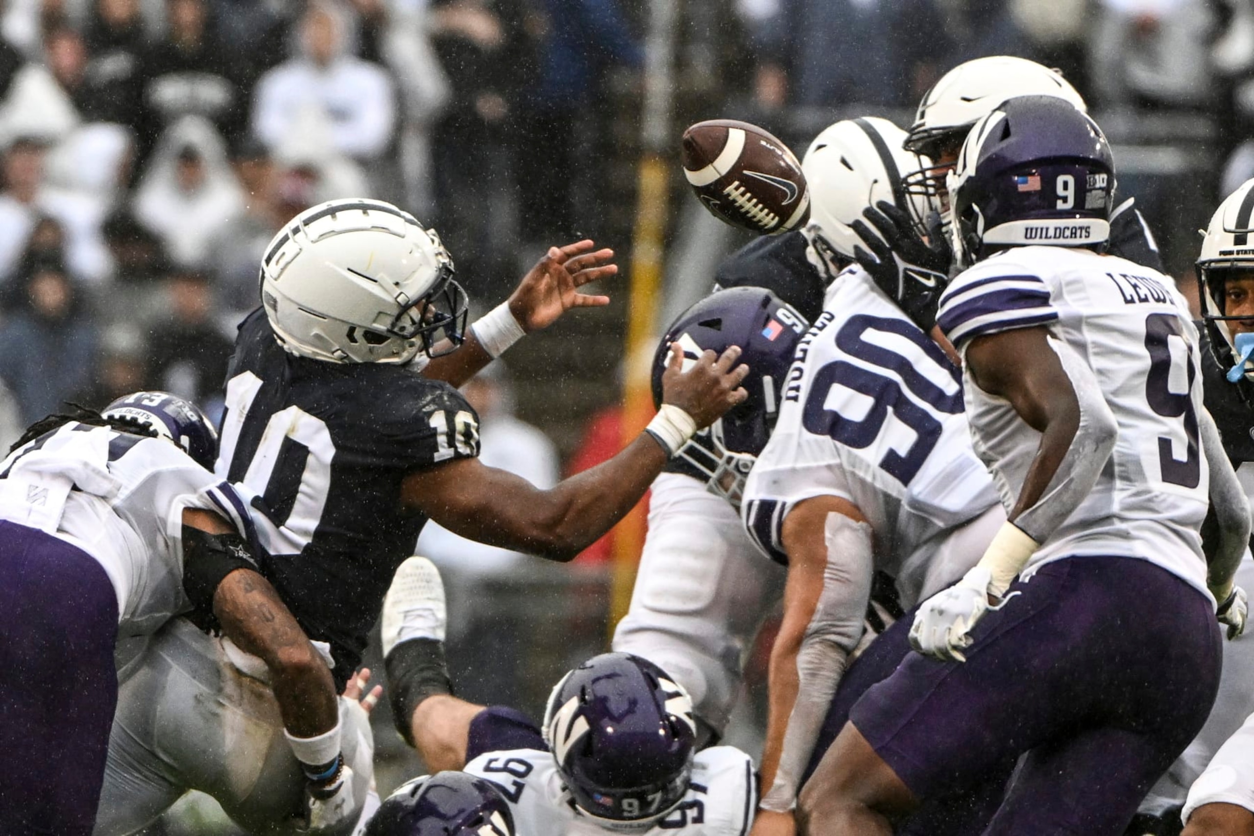 Penn State running back Nicholas Singleton (10) fumbles the ball against Northwestern during the first half of an NCAA college football game, Saturday, Oct. 1, 2022, in State College, Pa. (AP Photo/Barry Reeger)