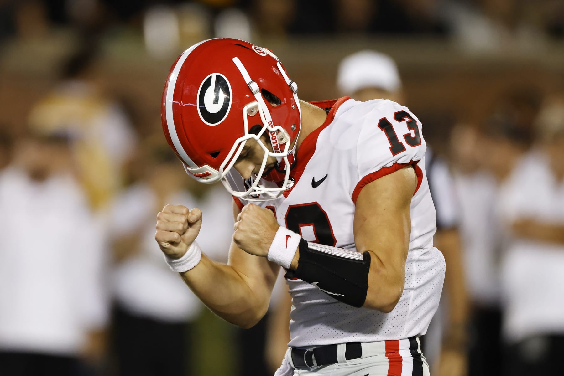 Georgia quarterback Stetson Bennett (13) reacts after a touchdown by running back Kendall Milton during the fourth quarter of an NCAA football game on Saturday, Oct. 1, 2022 in Columbia, Mo. (AP Photo/Colin E. Braley)