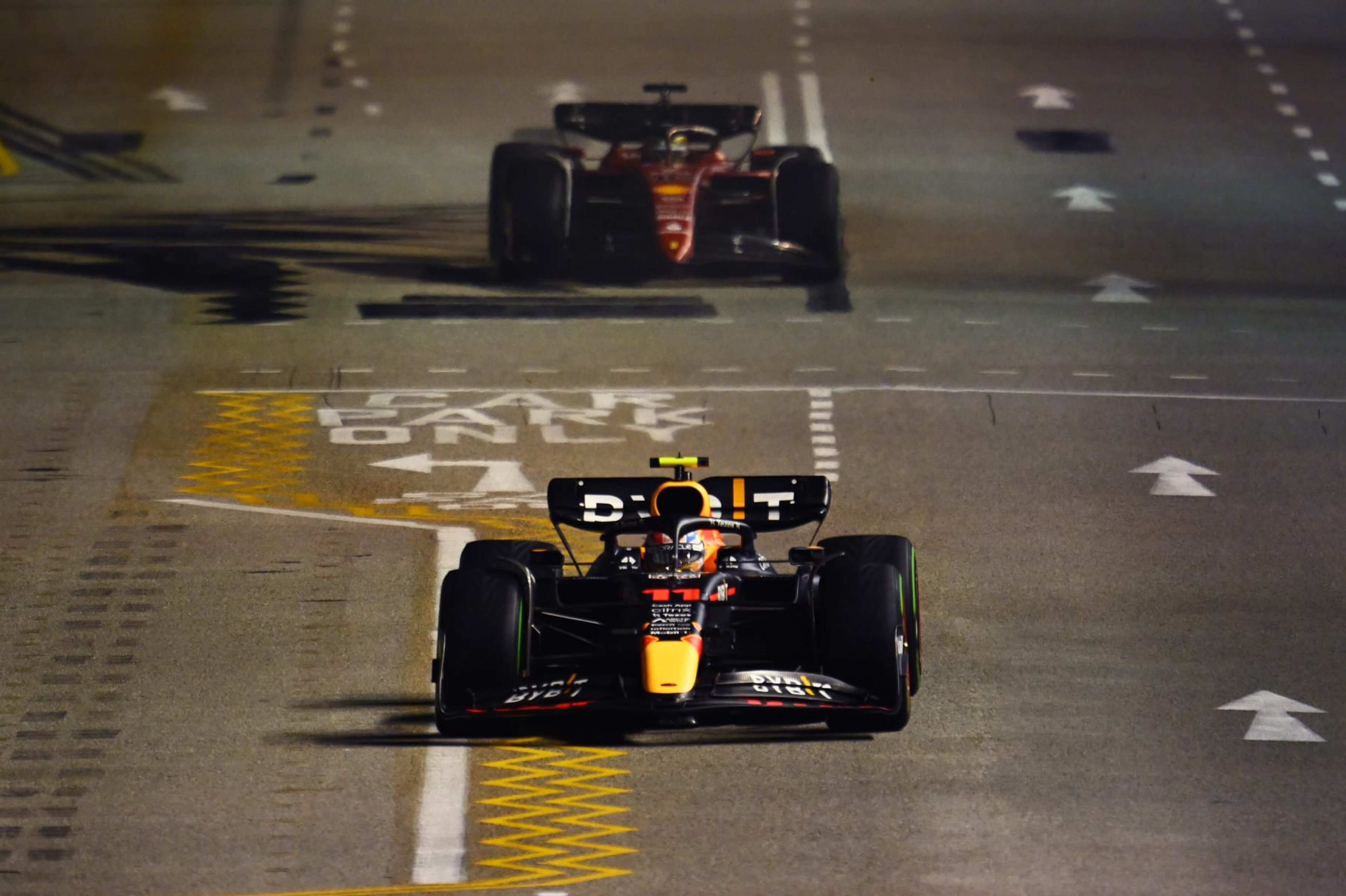 SINGAPORE, SINGAPORE - OCTOBER 02: Sergio Perez of Mexico driving the (11) Oracle Red Bull Racing RB18 leads Charles Leclerc of Monaco driving the (16) Ferrari F1-75 during the F1 Grand Prix of Singapore at Marina Bay Street Circuit on October 02, 2022 in Singapore, Singapore. (Photo by Clive Mason/Getty Images,) SINGAPORE, SINGAPORE - OCTOBER 02: Sergio Perez of Mexico driving the (11) Oracle Red Bull Racing RB18 leads Charles Leclerc of Monaco driving the (16) Ferrari F1-75 during the F1 Grand Prix of Singapore at Marina Bay Street Circuit on October 02, 2022 in Singapore, Singapore. (Photo by Clive Mason/Getty Images,)