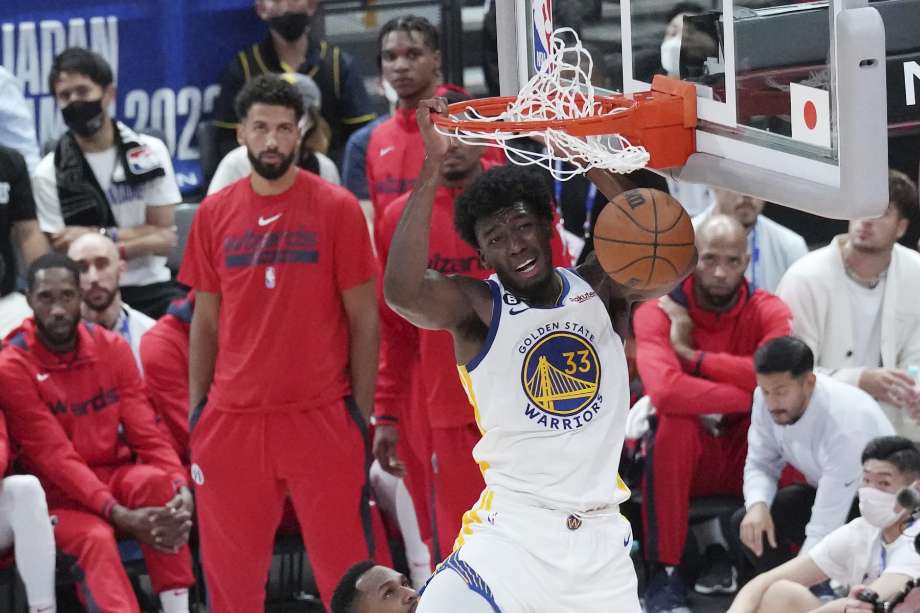 Golden State Warriors' James Wiseman dunks against Washington Wizards during their preseason NBA basketball game, Friday, Sept. 30, 2022, at Saitama Super Arena, in Saitama, north of Tokyo. (AP Photo/Eugene Hoshiko)