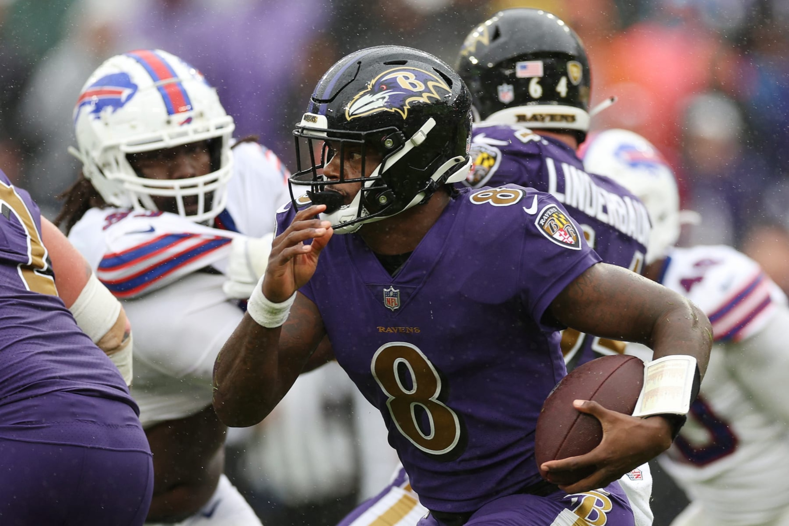 BALTIMORE, MARYLAND - OCTOBER 02: Lamar Jackson #8 of the Baltimore Ravens runs with the ball in the fourth quarter against the Buffalo Bills at M&T Bank Stadium on October 02, 2022 in Baltimore, Maryland. (Photo by Rob Carr/Getty Images)
