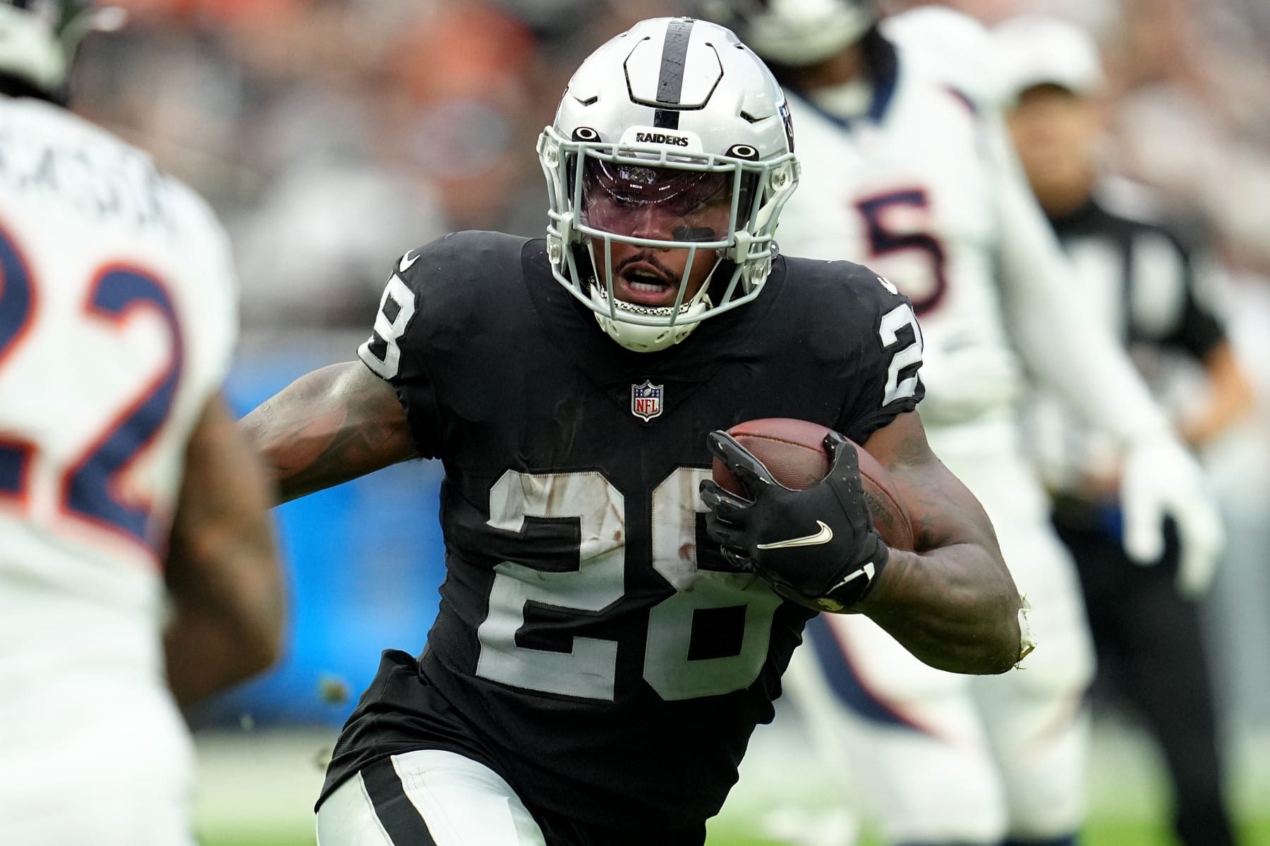 LAS VEGAS, NEVADA - OCTOBER 02: Josh Jacobs #28 of the Las Vegas Raiders runs with the ball in the first quarter against the Denver Broncos at Allegiant Stadium on October 02, 2022 in Las Vegas, Nevada. (Photo by Jeff Bottari/Getty Images)