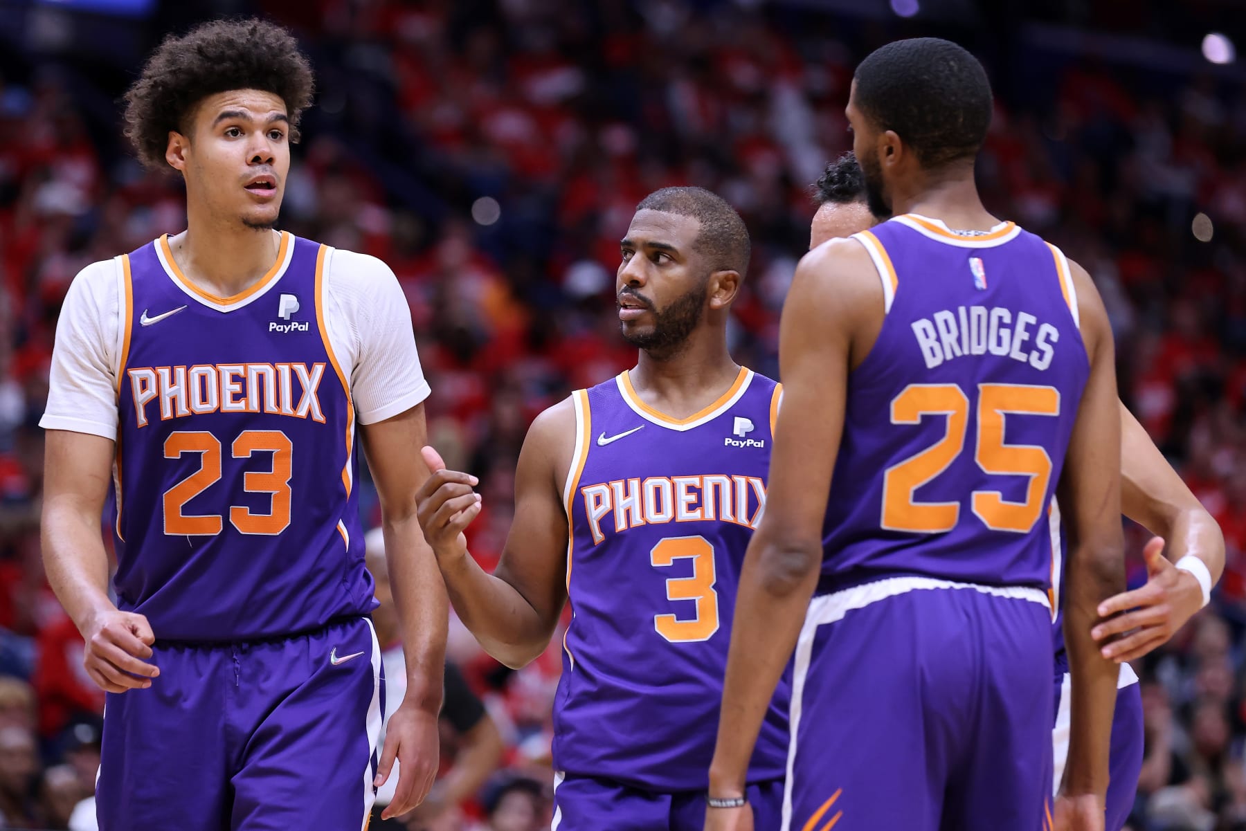 NEW ORLEANS, LOUISIANA - APRIL 24: Chris Paul #3, Cameron Johnson #23 an Mikal Bridges #25 of the Phoenix Suns react during Game Four of the Western Conference First Round NBA Playoffs against the New Orleans Pelicans at the Smoothie King Center on April 24, 2022 in New Orleans, Louisiana. NOTE TO USER: User expressly acknowledges and agrees that, by downloading and or using this Photograph, user is consenting to the terms and conditions of the Getty Images License Agreement. (Photo by Jonathan Bachman/Getty Images)