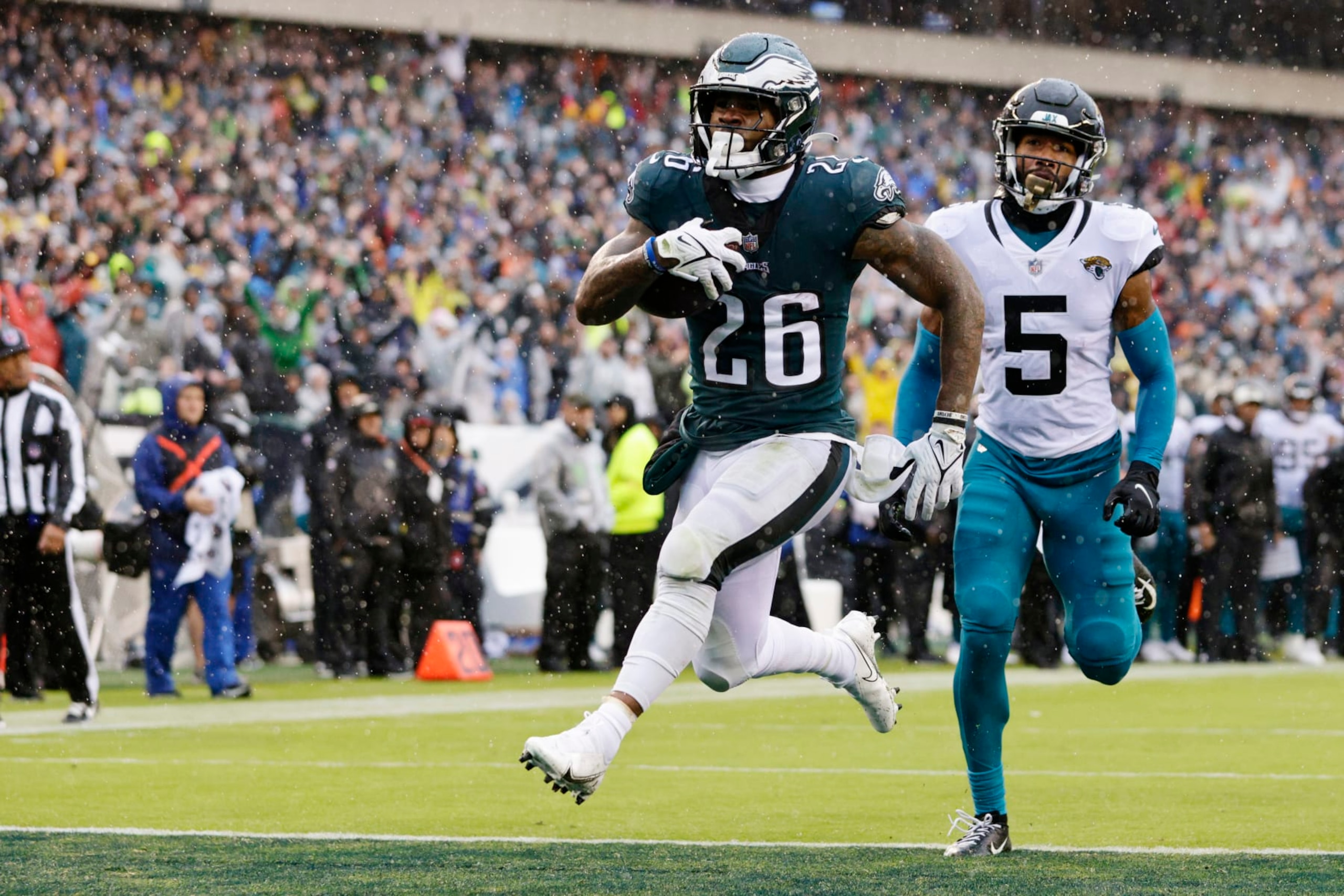 Philadelphia Eagles running back Miles Sanders (26) scores a touchdown on a run as Jacksonville Jaguars safety Andre Cisco (5) chases during the second quarter of an NFL football game, Sunday, Oct. 2, 2022, in Philadelphia. (AP Photo/Rich Schultz)