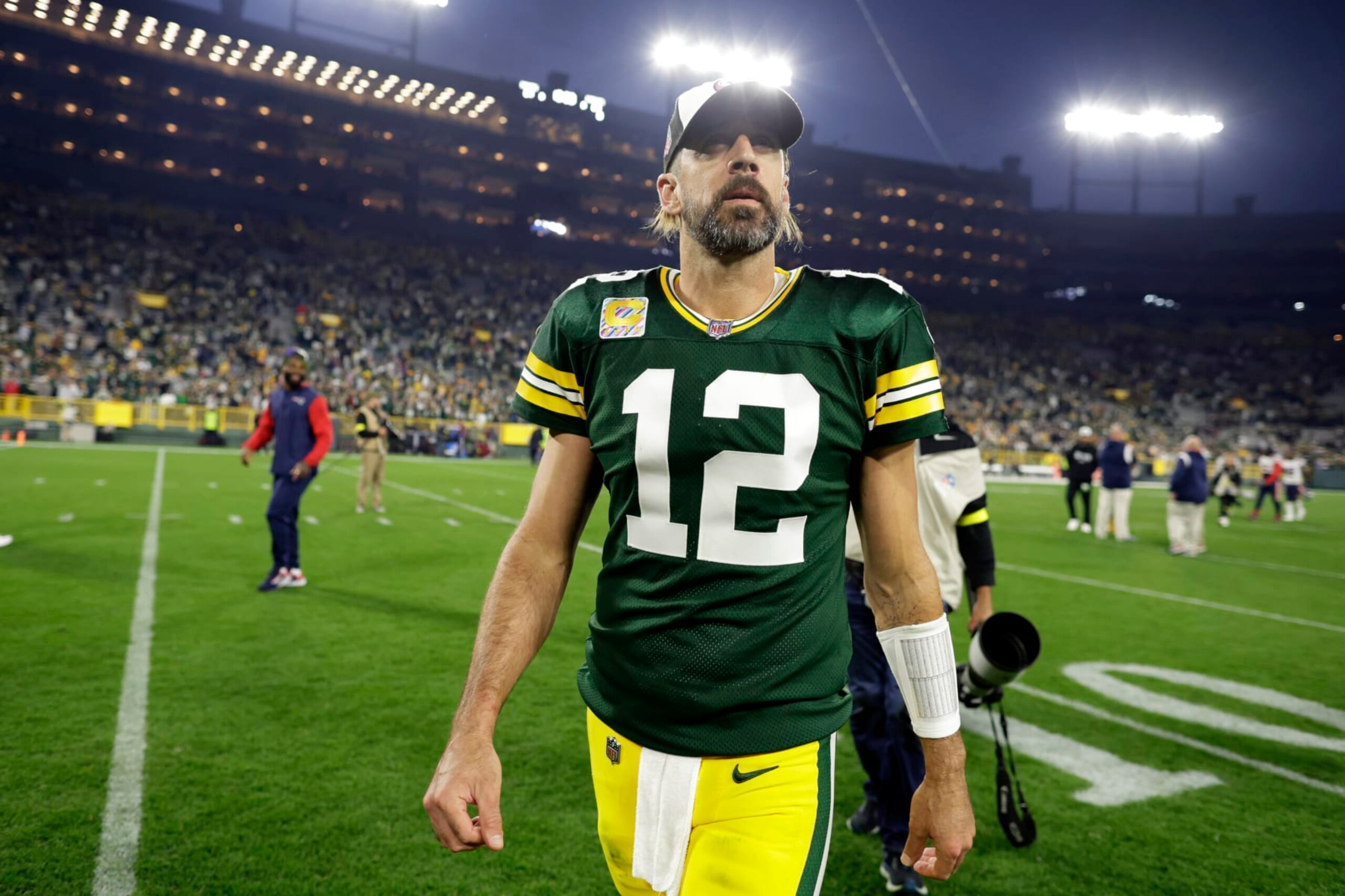 Green Bay Packers quarterback Aaron Rodgers walks off the field after an NFL football game against the New England Patriots, Sunday, Oct. 2, 2022, in Green Bay, Wis. The Packers won 27-24 in overtime. (AP Photo/Matt Ludtke)