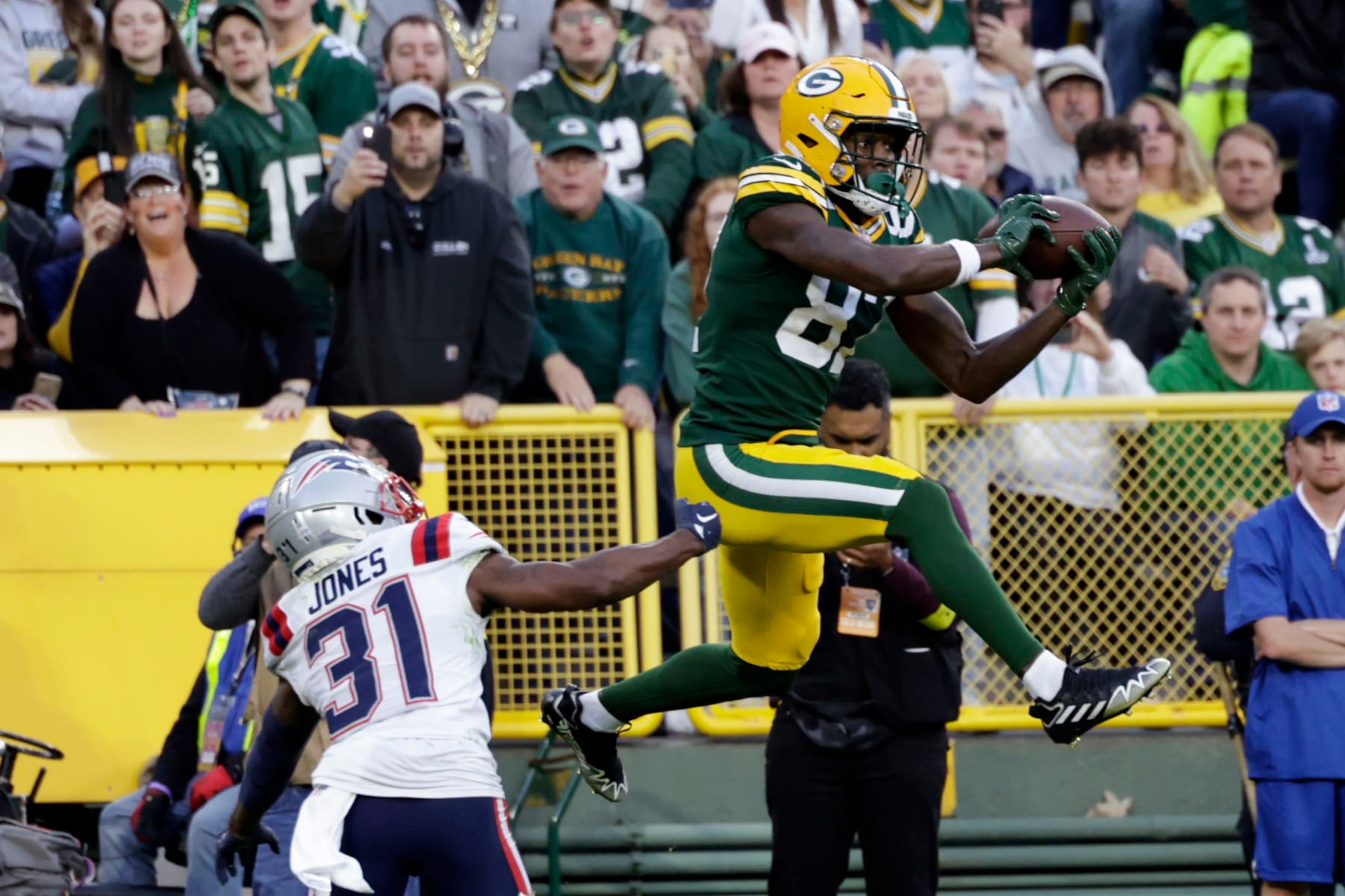 Green Bay Packers wide receiver Romeo Doubs (87) catches a 13-yard touchdown pass over New England Patriots cornerback Jonathan Jones (31) during the second half of an NFL football game, Sunday, Oct. 2, 2022, in Green Bay, Wis. (AP Photo/Matt Ludtke) Green Bay Packers wide receiver Romeo Doubs (87) catches a 13-yard touchdown pass over New England Patriots cornerback Jonathan Jones (31) during the second half of an NFL football game, Sunday, Oct. 2, 2022, in Green Bay, Wis. (AP Photo/Matt Ludtke)