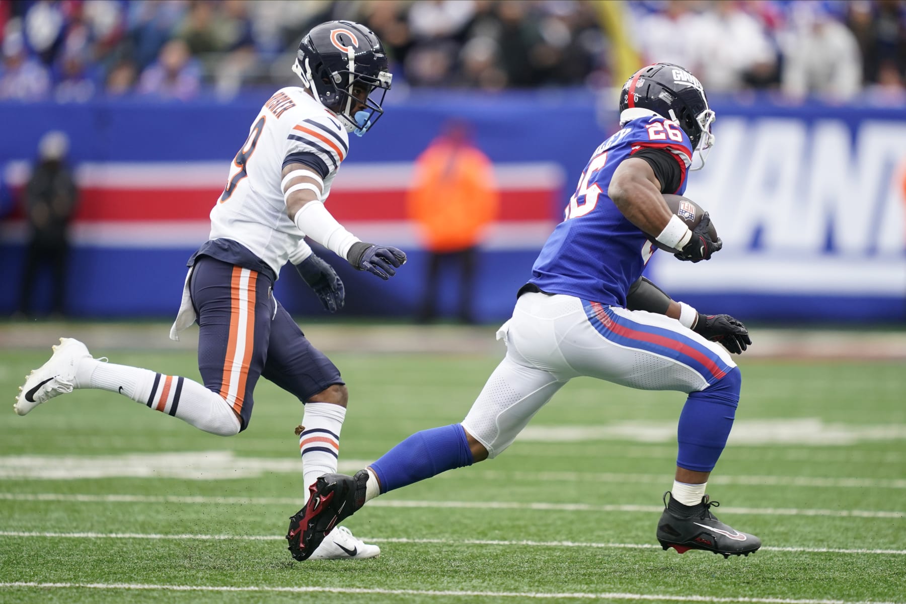 Chicago Bears safety Jaquan Brisker (9) chases down New York Giants running back Saquon Barkley (26) during the second quarter of an NFL football game, Sunday, Oct. 2, 2022, in East Rutherford, N.J. (AP Photo/John Minchillo)