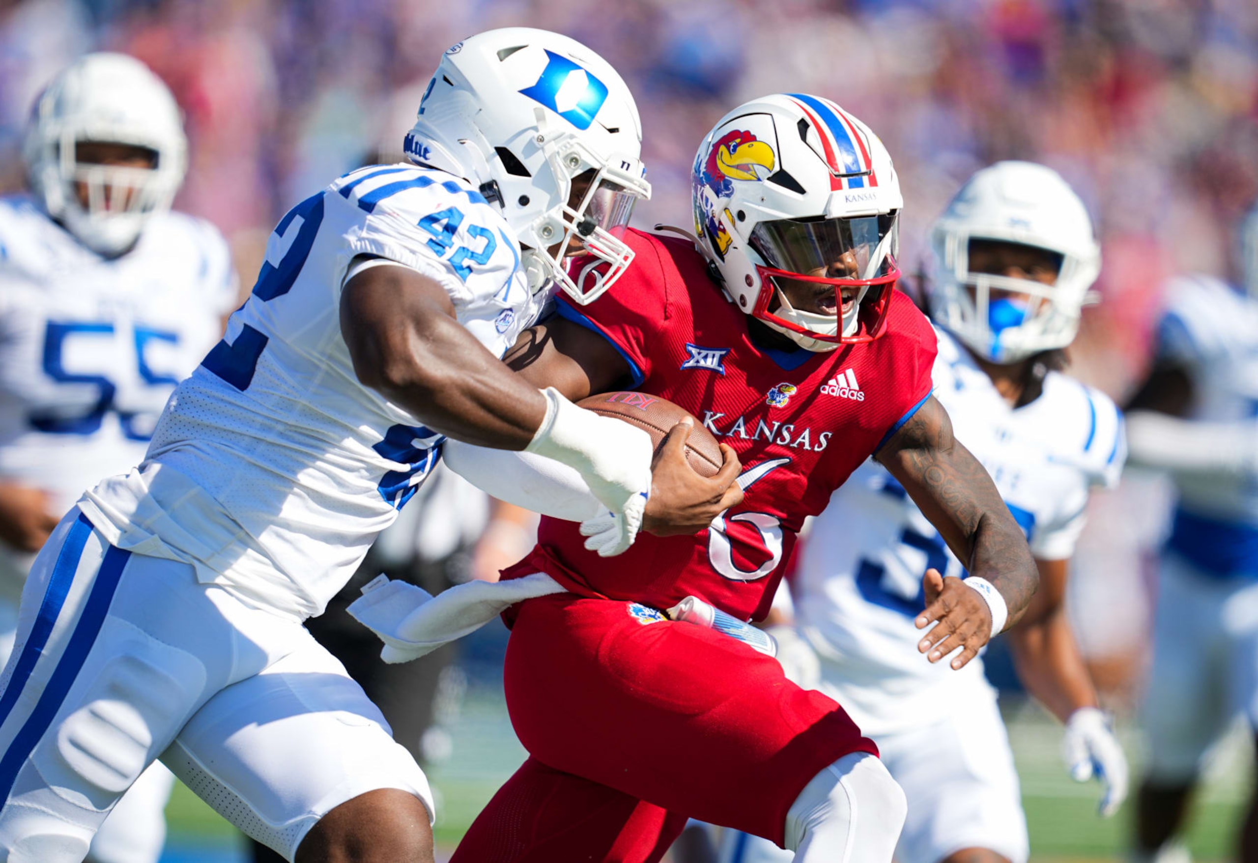 LAWRENCE, KS - SEPTEMBER 24: Jalon Daniels #6 of the Kansas Jayhawks runs the ball against Shaka Heyward #42 of the Duke Blue Devils during the first half at David Booth Kansas Memorial Stadium on September 24, 2022 in Lawrence, Kansas. (Photo by Jay Biggerstaff/Getty Images)