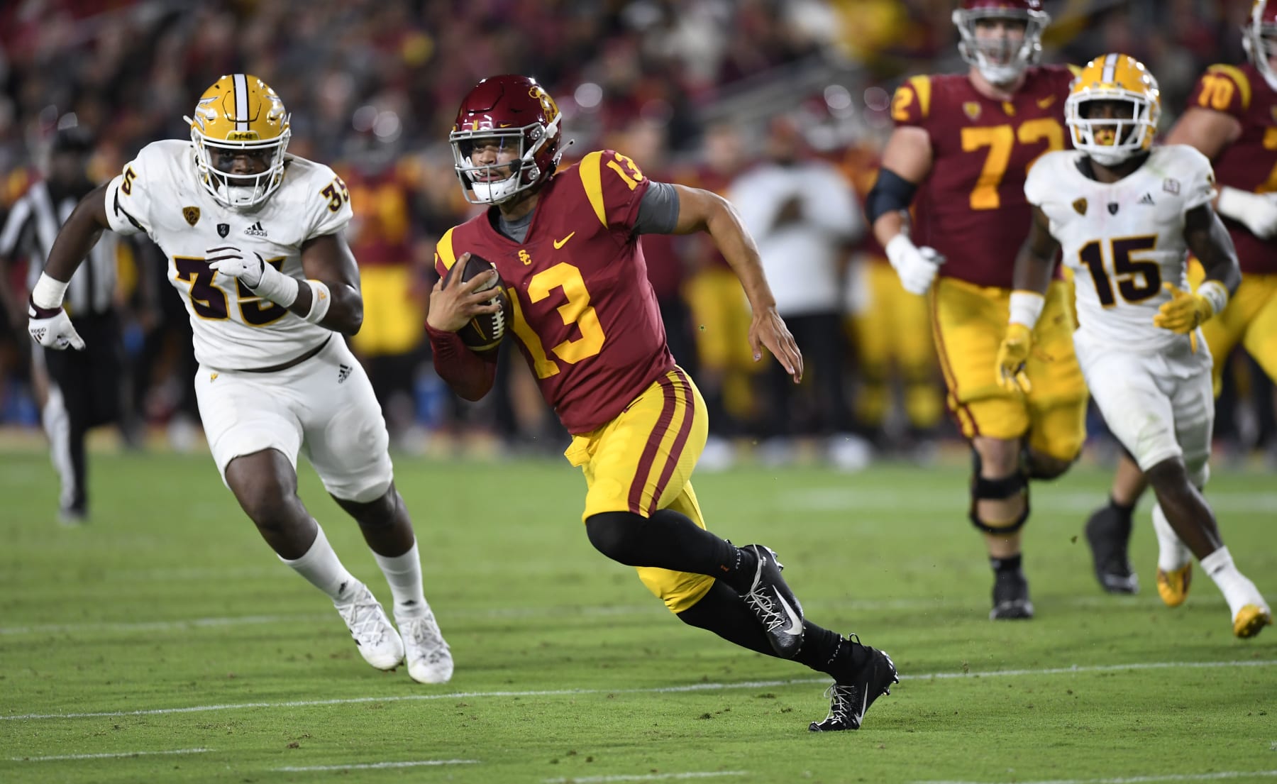 LOS ANGELES, CA - OCTOBER 01: Quarterback Caleb Williams #13 of the USC Trojans rushes out of the pocket and gains a first down B.J. Green II #35 of the Arizona State Sun Devils during the second half at United Airlines Field at the Los Angeles Memorial Coliseum on October 1, 2022 in Los Angeles, California. (Photo by Kevork Djansezian/Getty Images)