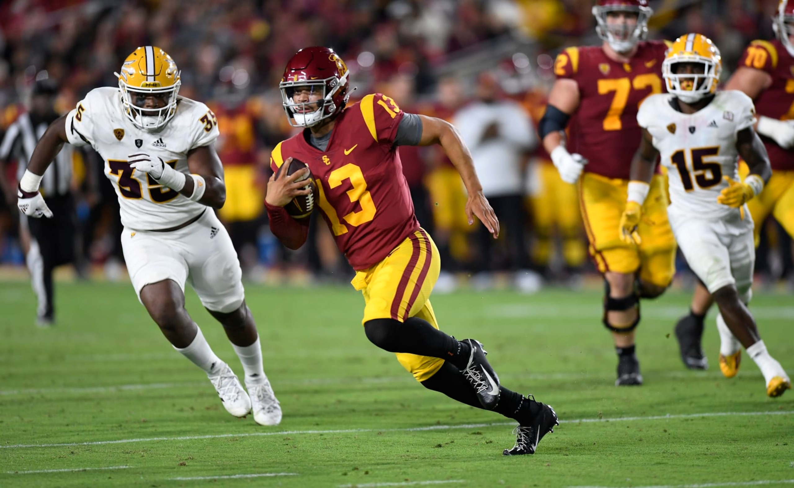 LOS ANGELES, CA - OCTOBER 01: Quarterback Caleb Williams #13 of the USC Trojans rushes out of the pocket and gains a first down B.J. Green II #35 of the Arizona State Sun Devils during the second half at United Airlines Field at the Los Angeles Memorial Coliseum on October 1, 2022 in Los Angeles, California. (Photo by Kevork Djansezian/Getty Images)