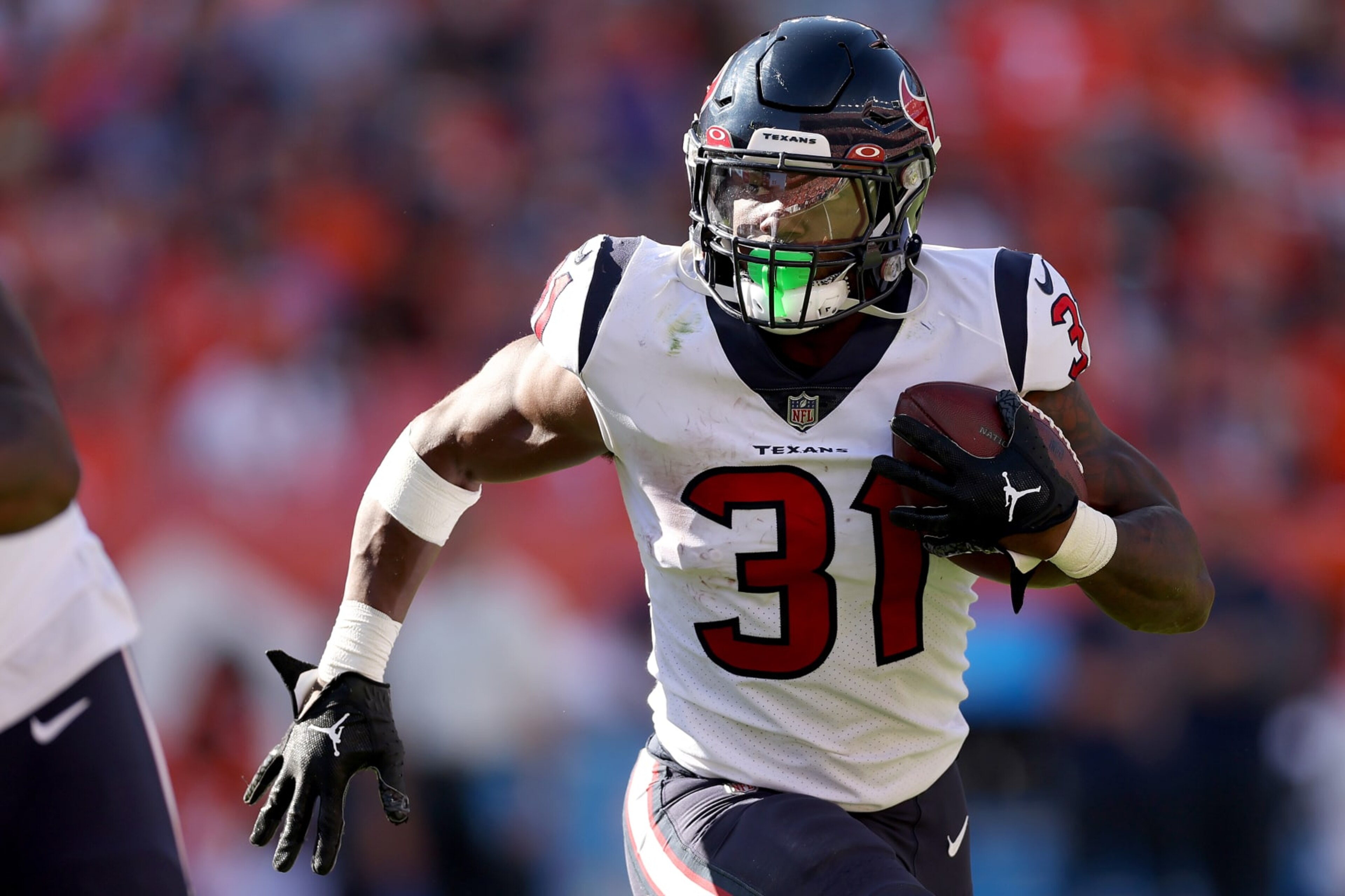 DENVER, COLORADO - SEPTEMBER 18: Dameon Pierce #31 of the Houston Texans carries the ball against the Denver Broncos at Empower Field At Mile High on September 18, 2022 in Denver, Colorado. (Photo by Matthew Stockman/Getty Images)