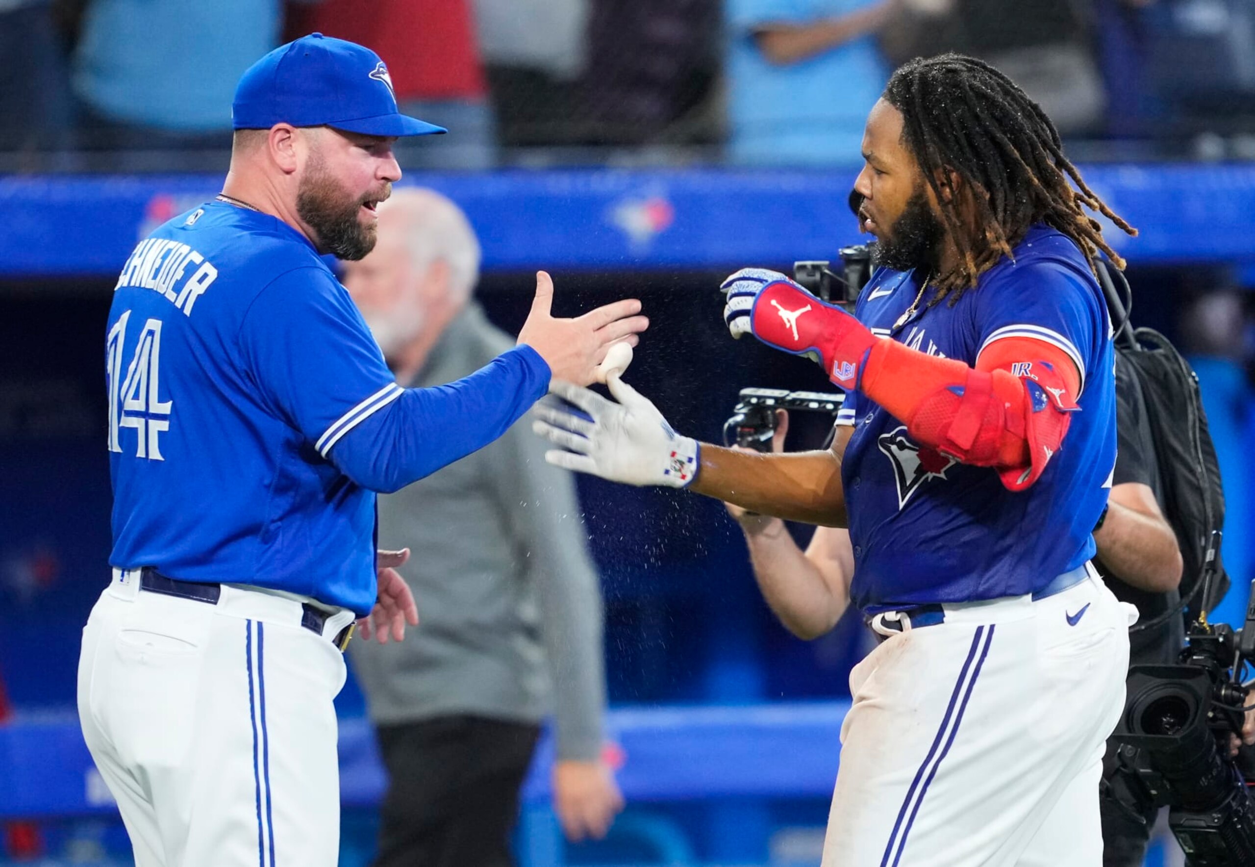 TORONTO, ON - SEPTEMBER 26: Vladimir Guerrero Jr. #27 of the Toronto Blue Jays celebrates on his walk-off hit with manager John Schneider to defeat the the New York Yankees in the tenth inning during their MLB game at the Rogers Centre on September 26, 2022 in Toronto, Ontario, Canada. (Photo by Mark Blinch/Getty Images)
