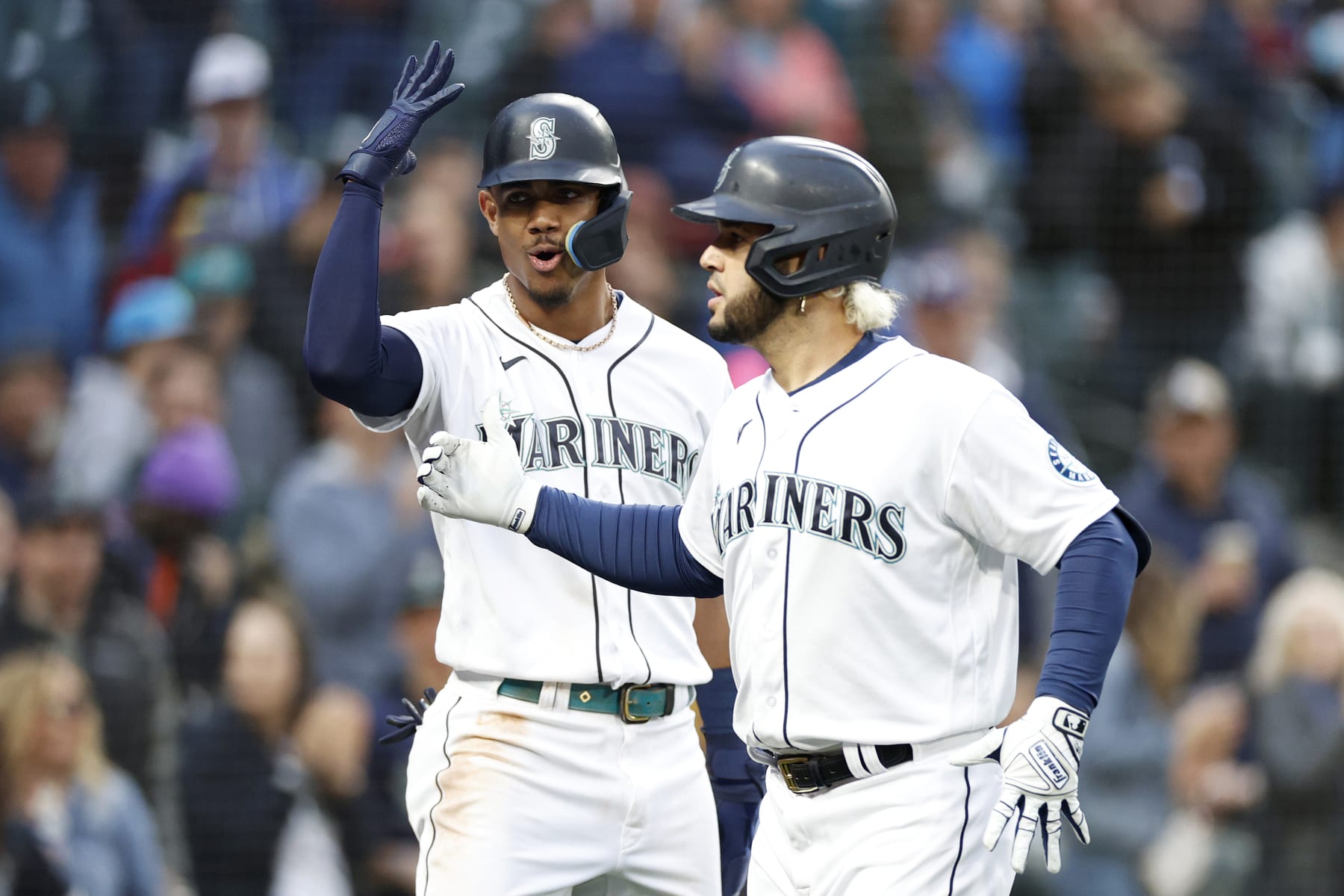 SEATTLE, WASHINGTON - JUNE 14: Eugenio Suarez #28 of the Seattle Mariners celebrates with Julio Rodriguez #44 after hitting a two-run home run during the fourth inning against the Minnesota Twins at T-Mobile Park on June 14, 2022 in Seattle, Washington. (Photo by Steph Chambers/Getty Images)