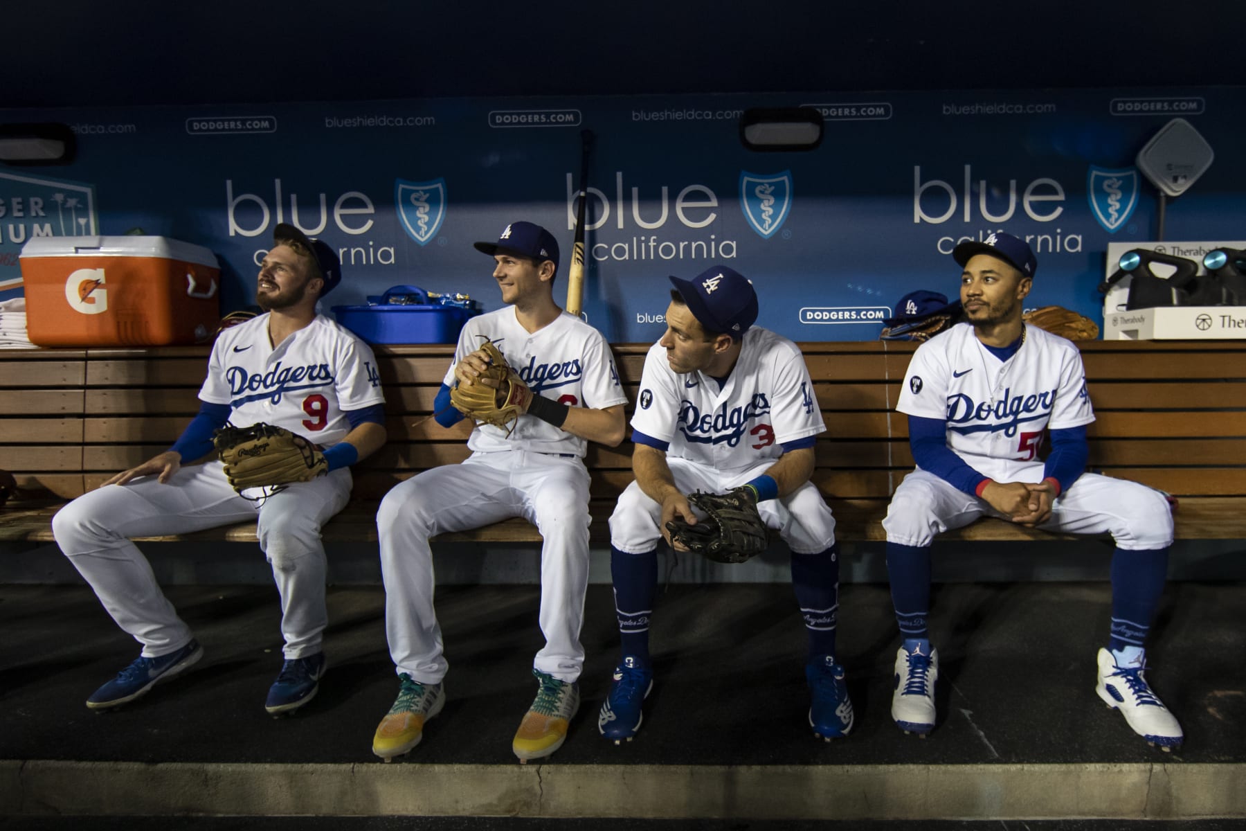 LOS ANGELES, CA - SEPTEMBER 20: From left to right, Los Angeles Dodgers Gavin Lux (9), Trea Turner (6), Chris Taylor (3), and Mookie Betts (50) sit in the dugout prior to game 2 of a doubleheader against the Arizona Diamondbacks on September 20, 2022, at Dodger Stadium in Los Angeles, CA. (Photo by Brandon Sloter/Icon Sportswire via Getty Images)