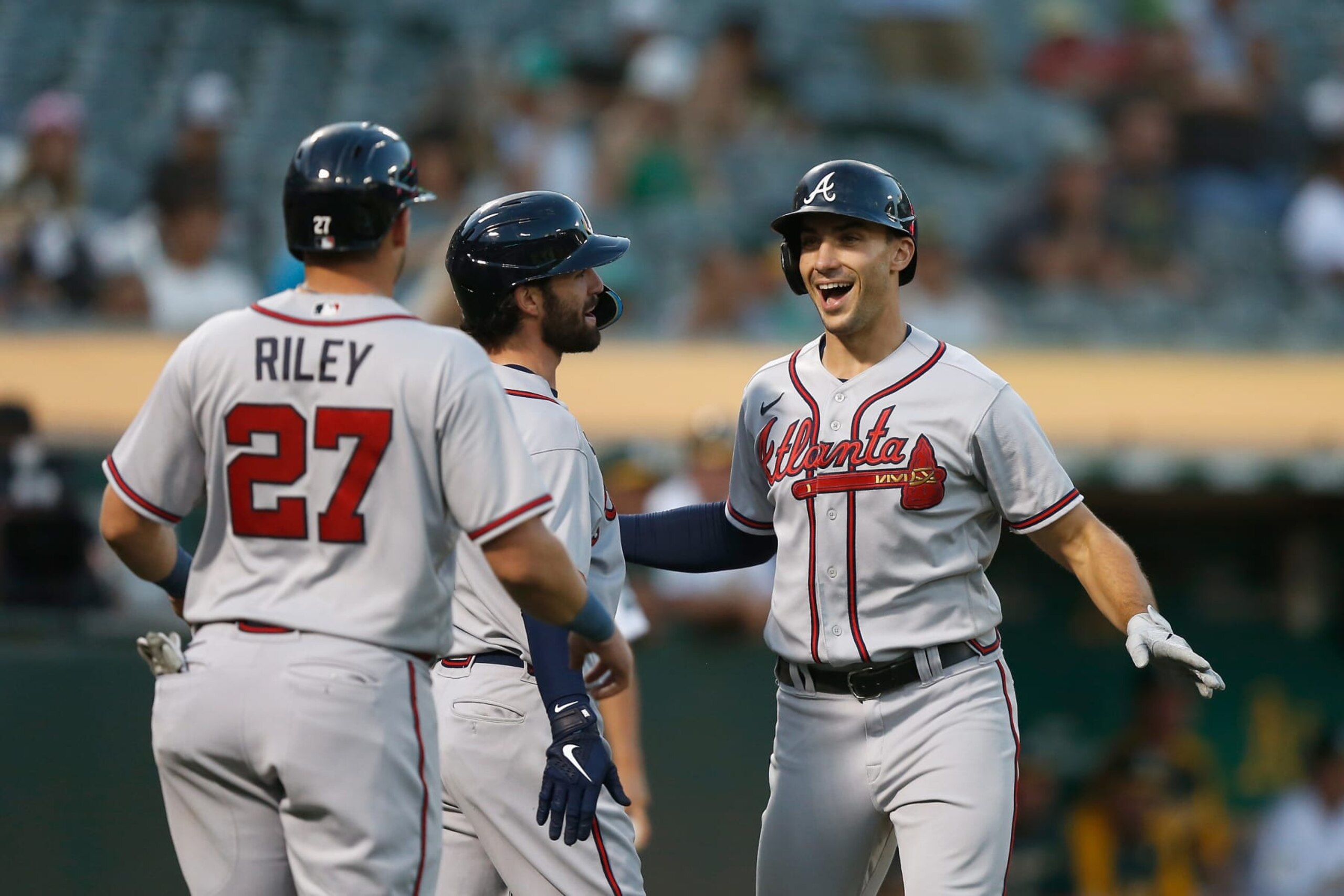 OAKLAND, CALIFORNIA - SEPTEMBER 06: Matt Olson #28 of the Atlanta Braves celebrates with Austin Riley #27 and Dansby Swanson #7 after hitting a three-run home run in the top of the third inning against the Oakland Athletics at RingCentral Coliseum on September 06, 2022 in Oakland, California. (Photo by Lachlan Cunningham/Getty Images)