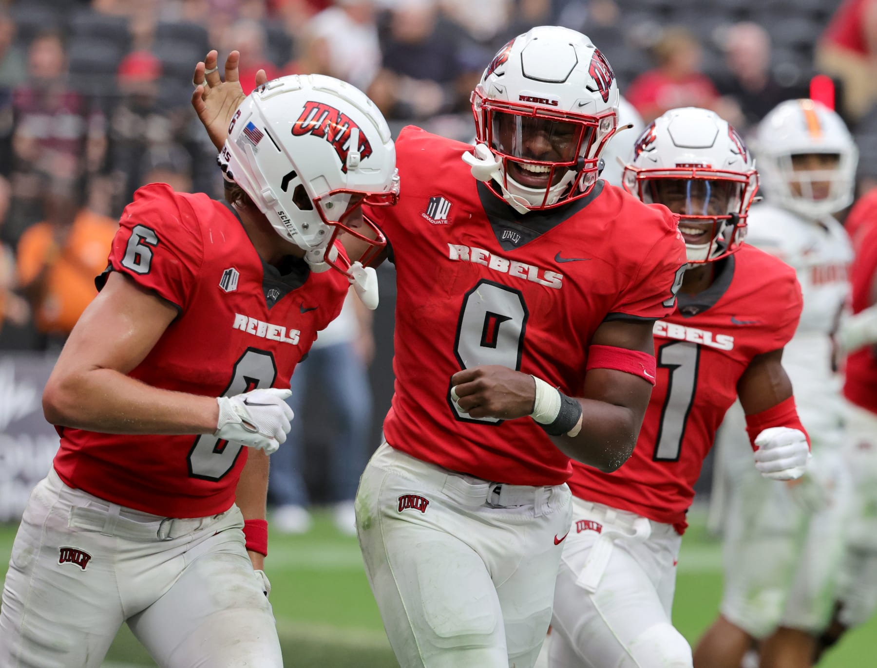 LAS VEGAS, NEVADA - AUGUST 27: Wide receiver Jeff Weimer #6, running back Aidan Robbins #9 and wide receiver Kyle Williams #1 of the UNLV Rebels celebrate in the end zone after Robbins scored his third touchdown of the game against the Idaho State Bengals at Allegiant Stadium on August 27, 2022 in Las Vegas, Nevada. (Photo by Ethan Miller/Getty Images)