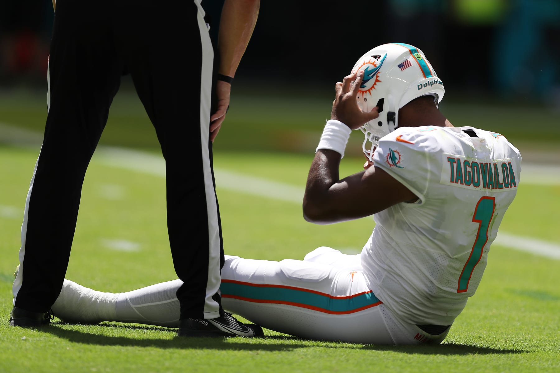 MIAMI GARDENS, FLORIDA - SEPTEMBER 25: Quarterback Tua Tagovailoa #1 of the Miami Dolphins sits on the turf during the first half of the game against the Buffalo Bills at Hard Rock Stadium on September 25, 2022 in Miami Gardens, Florida. (Photo by Megan Briggs/Getty Images)