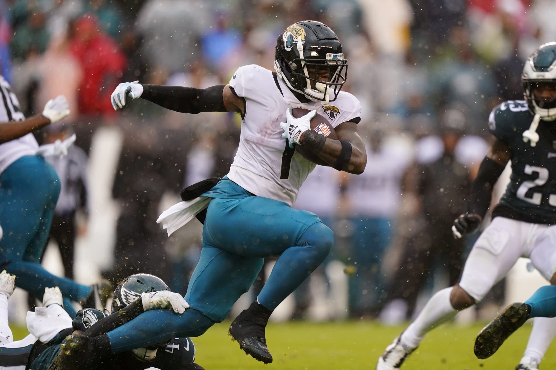 Jacksonville Jaguars' Travis Etienne Jr. runs with the ball under pressure during the first half of an NFL football game against the Philadelphia Eagles on Sunday, Oct. 2, 2022, in Philadelphia. (AP Photo/Matt Slocum)