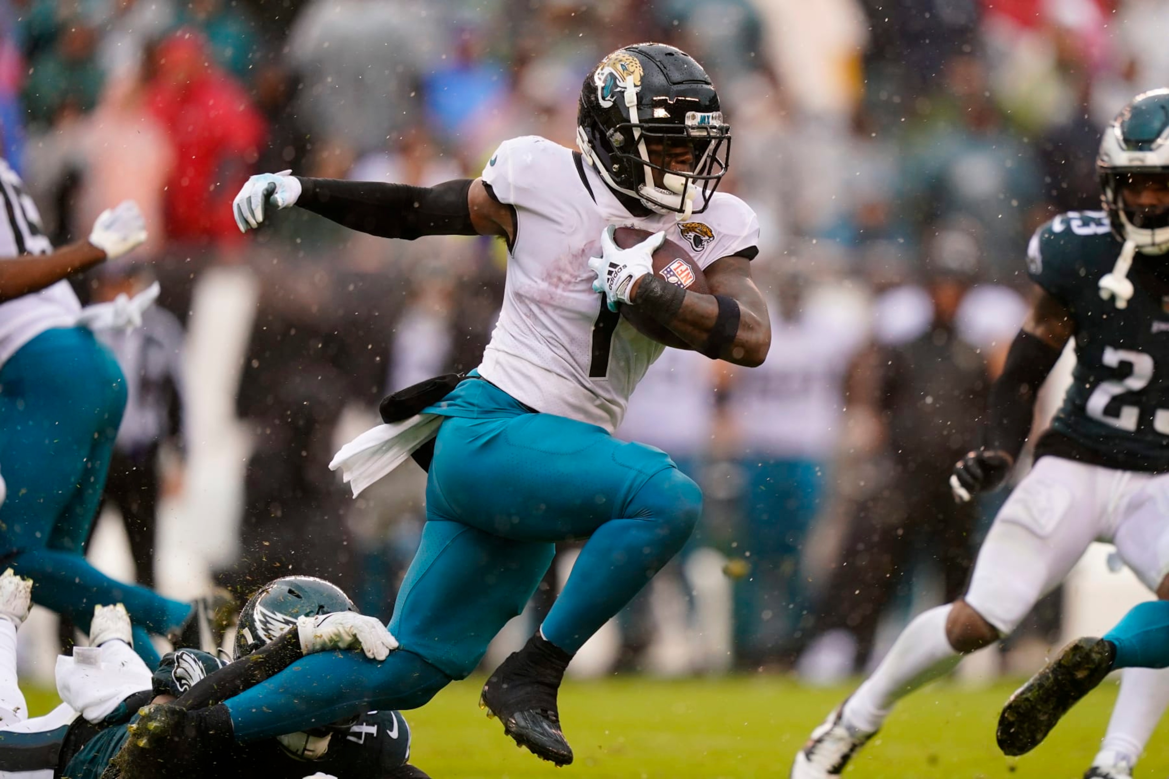 Jacksonville Jaguars' Travis Etienne Jr. runs with the ball under pressure during the first half of an NFL football game against the Philadelphia Eagles on Sunday, Oct. 2, 2022, in Philadelphia. (AP Photo/Matt Slocum)