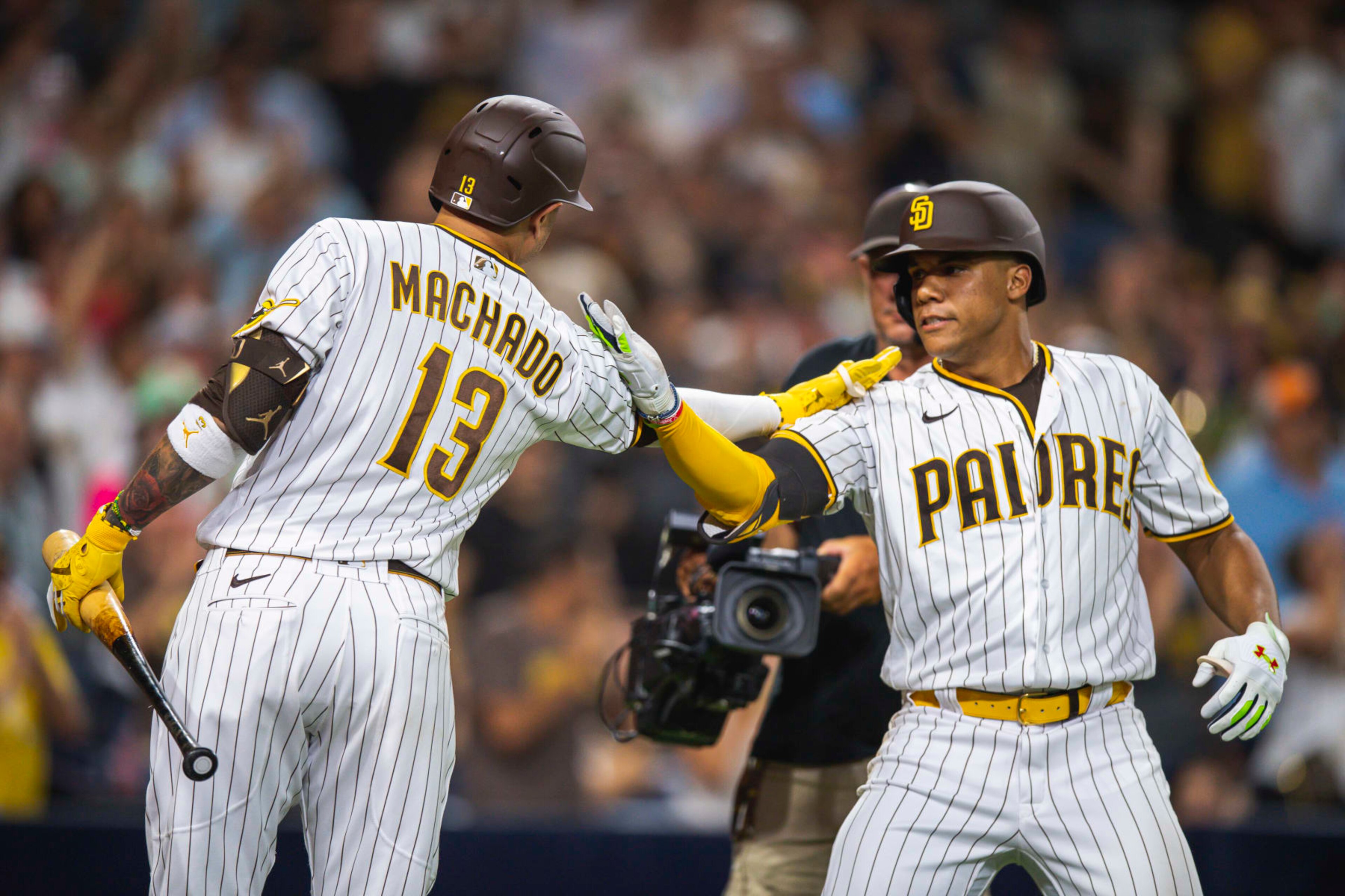 SAN DIEGO, CA - AUGUST 20: Juan Soto #22  celebrates at home plate with Manny Machado #13 of the San Diego Padres after hitting a home run in the seventh inning against the Washington Nationals at the PETCO Park on August 20, 2022 in San Diego, California. (Photo by Matt Thomas/San Diego Padres/Getty Images)