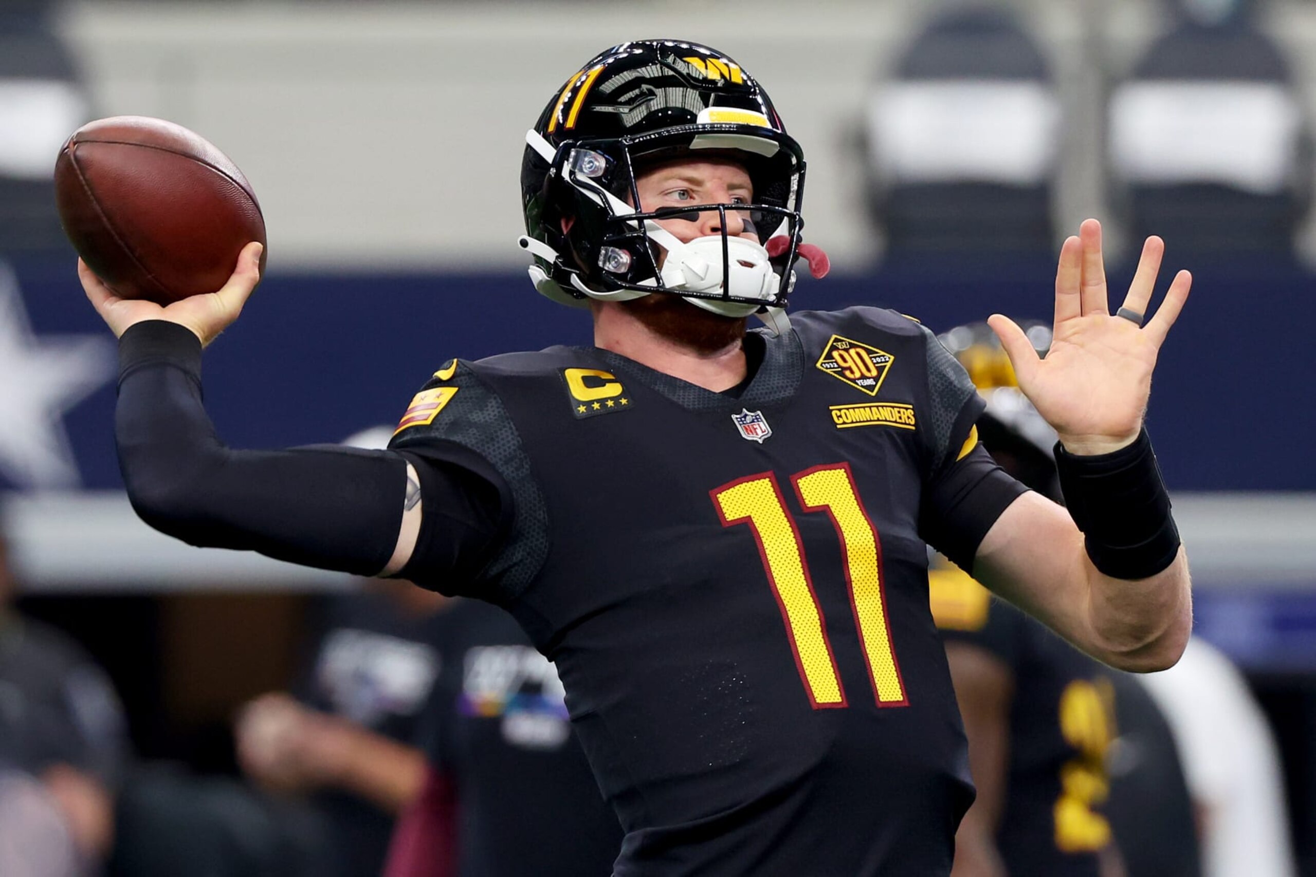 ARLINGTON, TEXAS - OCTOBER 02: Carson Wentz #11 of the Washington Commanders warms up before his game against the Dallas Cowboys at AT&T Stadium on October 02, 2022 in Arlington, Texas. (Photo by Richard Rodriguez/Getty Images)