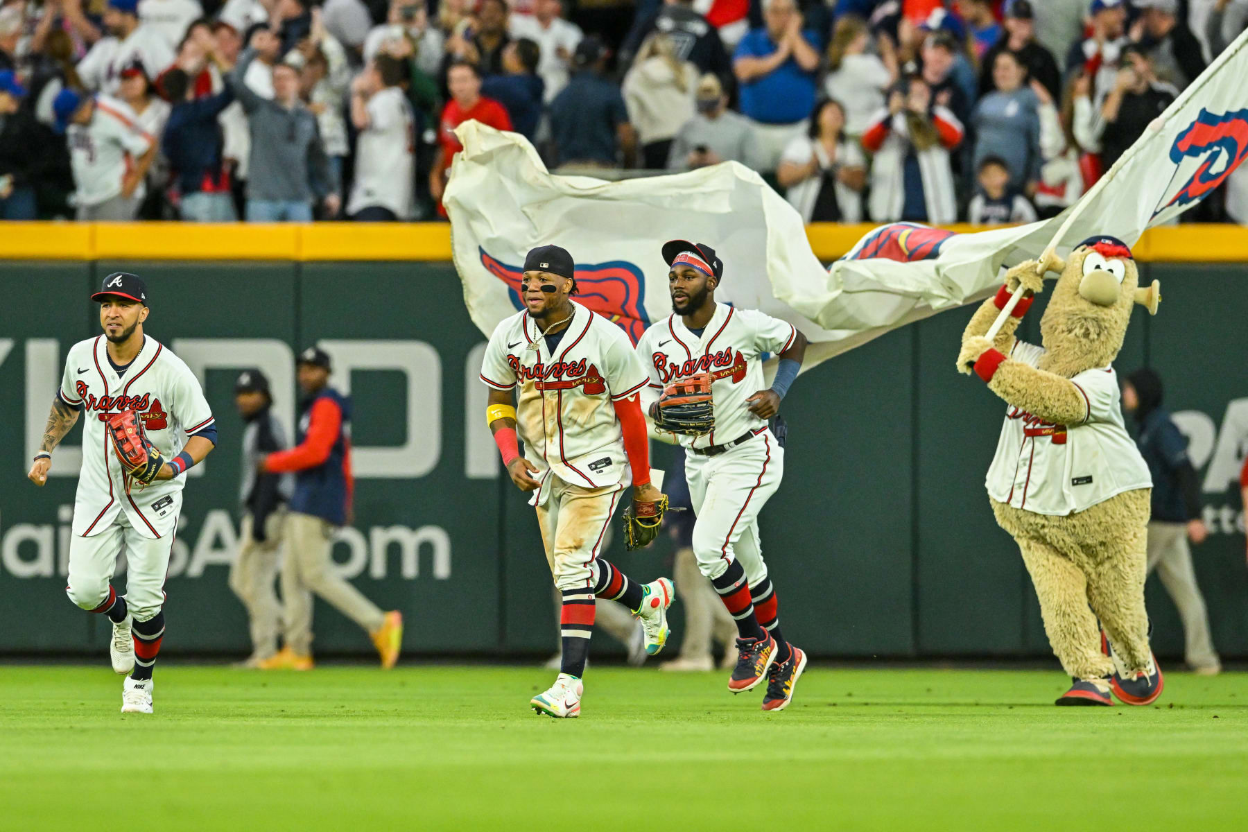 ATLANTA, GA  OCTOBER 01:  Atlanta outfielders Eddie Rosario (8), Ronald Acuna Jr. (13), and Michael Harris II (23) celebrate following the final out during the MLB game between the New York Mets and the Atlanta Braves on October 1st, 2022 at Truist Park in Atlanta, GA. (Photo by Rich von Biberstein/Icon Sportswire via Getty Images)