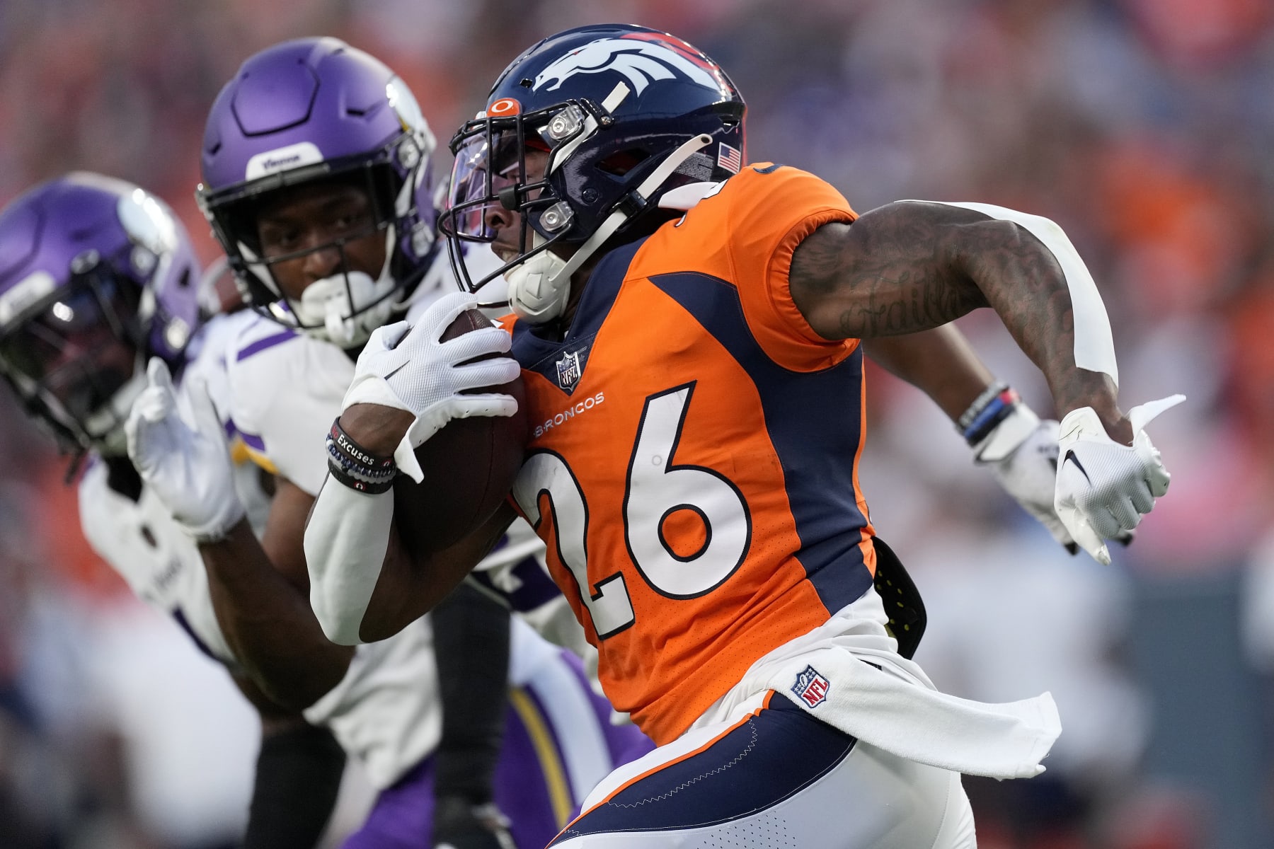 Denver Broncos running back Mike Boone (26) runs against the Minnesota Vikings during the first half of an NFL preseason football game, Saturday, Aug. 27, 2022, in Denver. (AP Photo/David Zalubowski)
