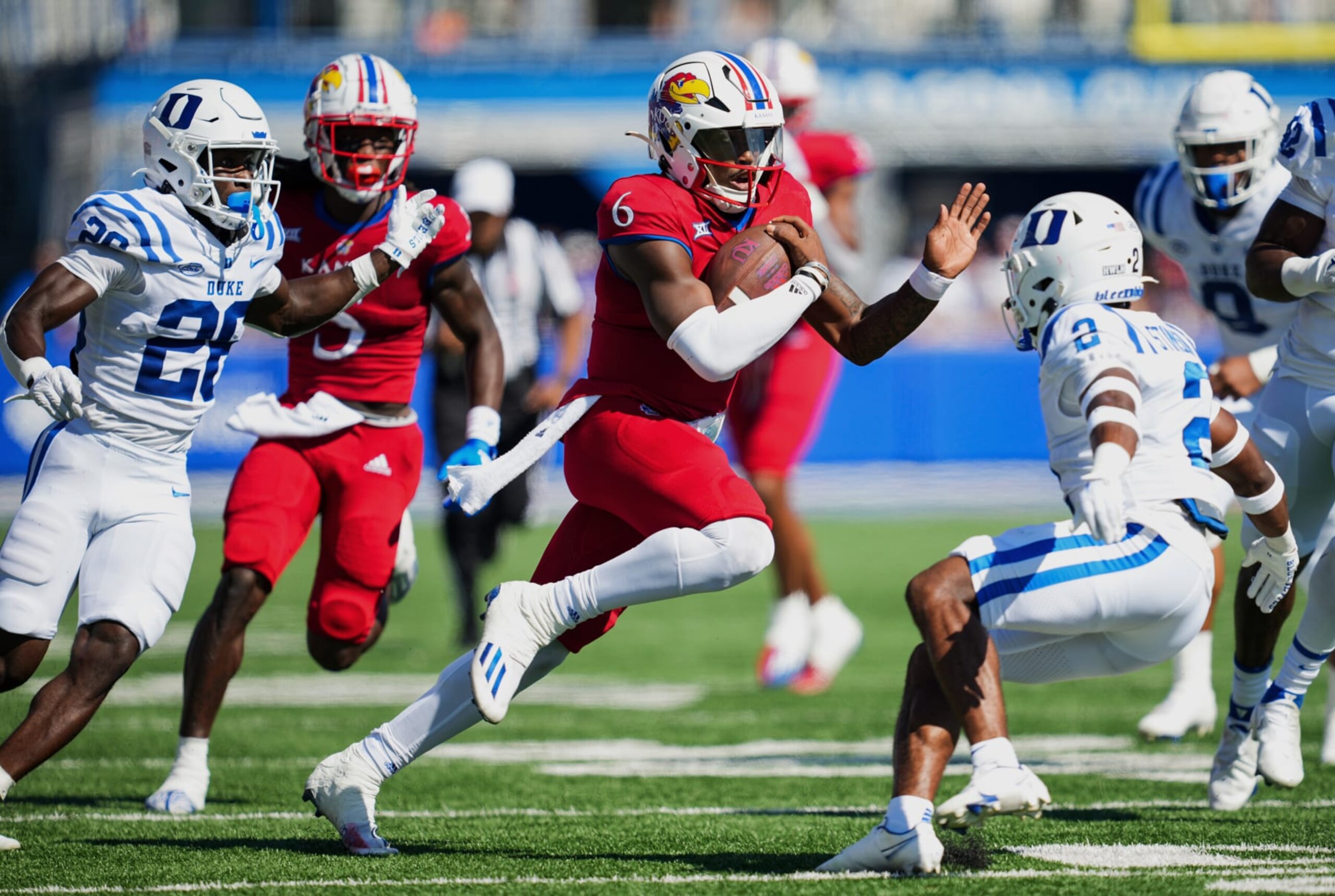 LAWRENCE, KS - SEPTEMBER 24: Jalon Daniels #6 of the Kansas Jayhawks runs the ball against Joshua Pickett #26 and Jaylen Stinson #2 of the Duke Blue Devils during the first half at David Booth Kansas Memorial Stadium on September 24, 2022 in Lawrence, Kansas. (Photo by Jay Biggerstaff/Getty Images) LAWRENCE, KS - SEPTEMBER 24: Jalon Daniels #6 of the Kansas Jayhawks runs the ball against Joshua Pickett #26 and Jaylen Stinson #2 of the Duke Blue Devils during the first half at David Booth Kansas Memorial Stadium on September 24, 2022 in Lawrence, Kansas. (Photo by Jay Biggerstaff/Getty Images)