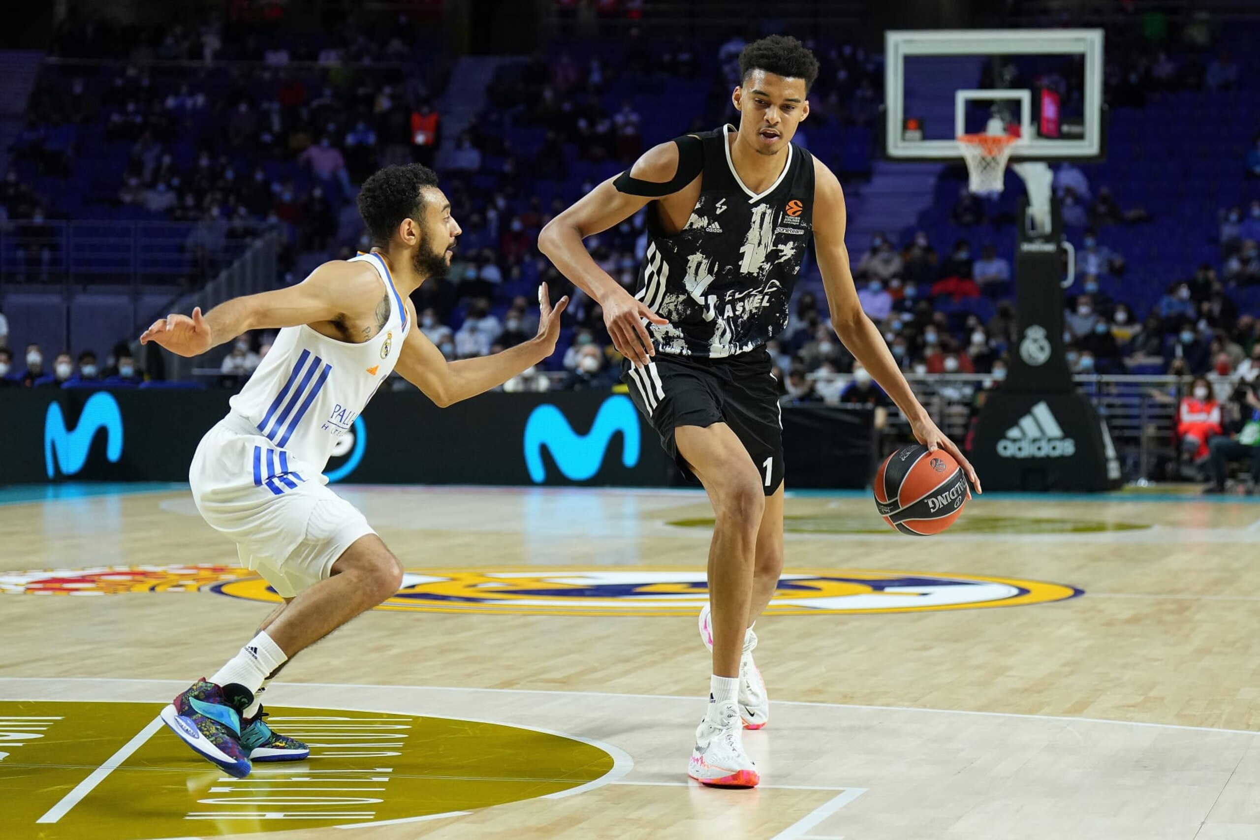 MADRID, SPAIN - MARCH 17: Victor Wembanyama, #1 of LDLC Asvel Villeurbanne is challenged by Nigel Williams-Goss, #0 of Real Madrid during the Turkish Airlines EuroLeague match between Real Madrid and LDLC Asvel Villeurbanne at Wizink Center on March 17, 2022 in Madrid, Spain. (Photo by Angel Martinez/Euroleague Basketball via Getty Images)