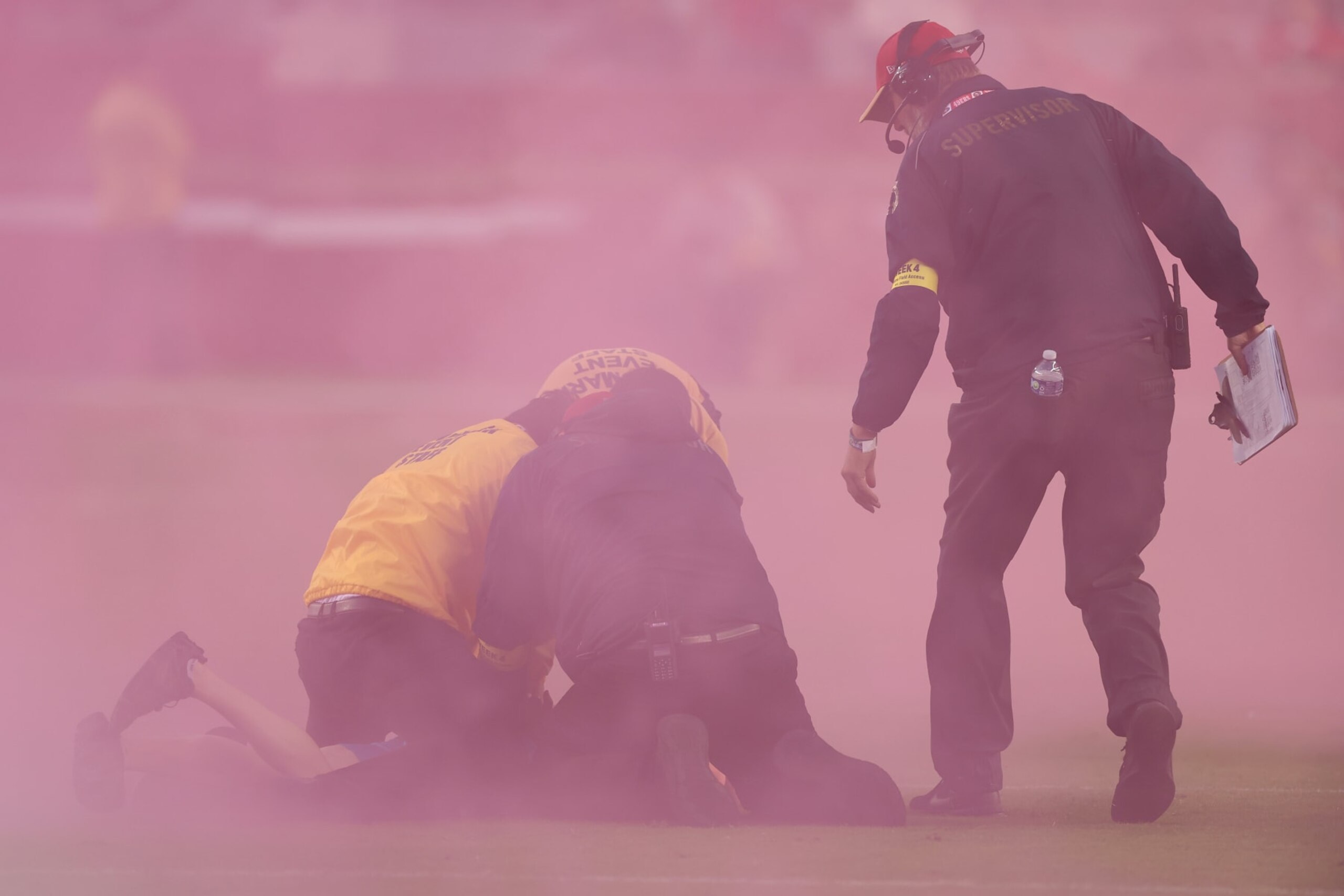SANTA CLARA, CALIFORNIA - OCTOBER 03: A fan is detained by security after running onto the field as the Los Angeles Rams play against the San Francisco 49ers at Levi's Stadium on October 03, 2022 in Santa Clara, California. (Photo by Ezra Shaw/Getty Images)