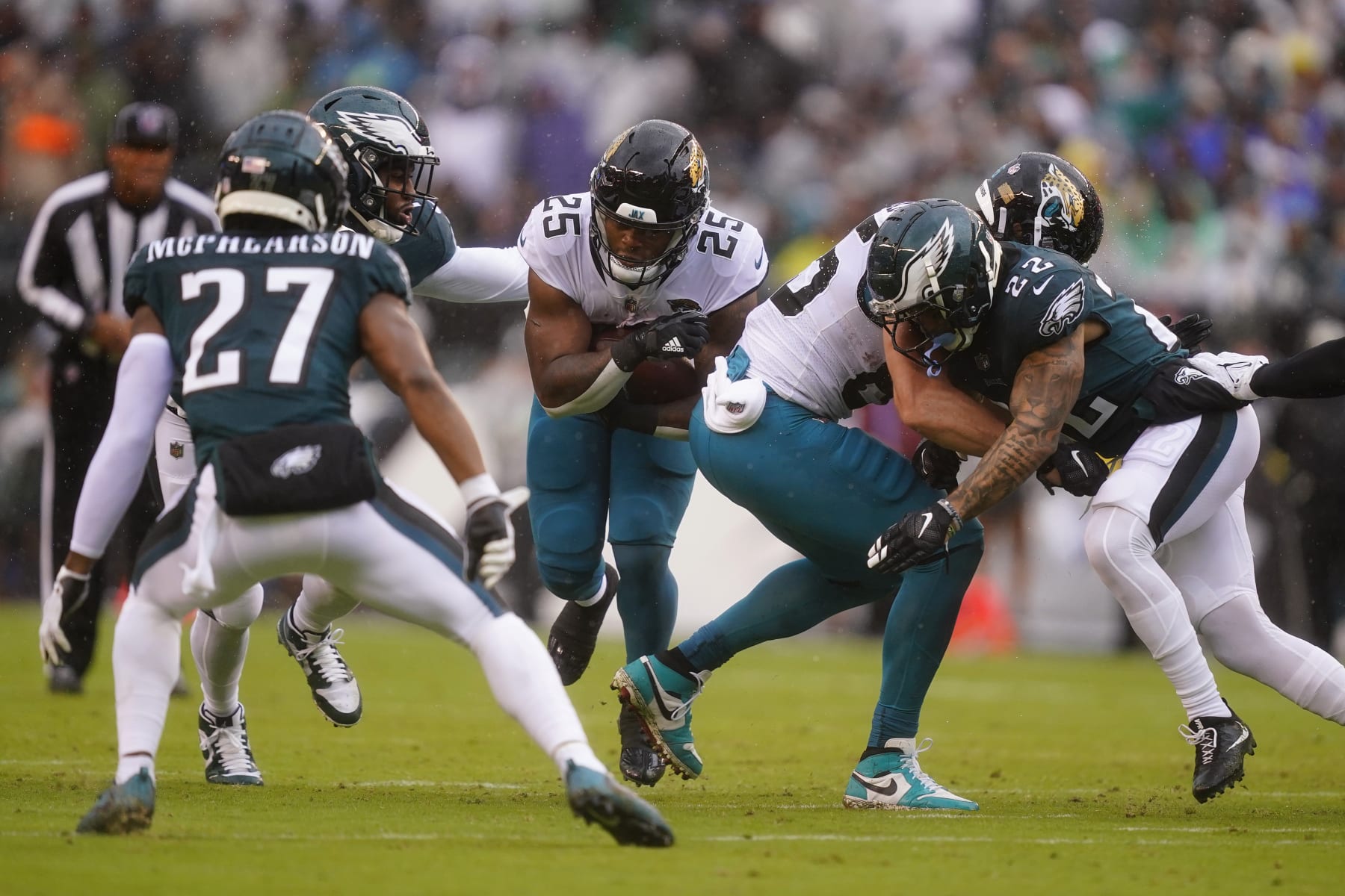 Jacksonville Jaguars' James Robinson, center, runs with the ball during the first half of an NFL football game against the Philadelphia Eagles on Sunday, Oct. 2, 2022, in Philadelphia. (AP Photo/Matt Rourke)