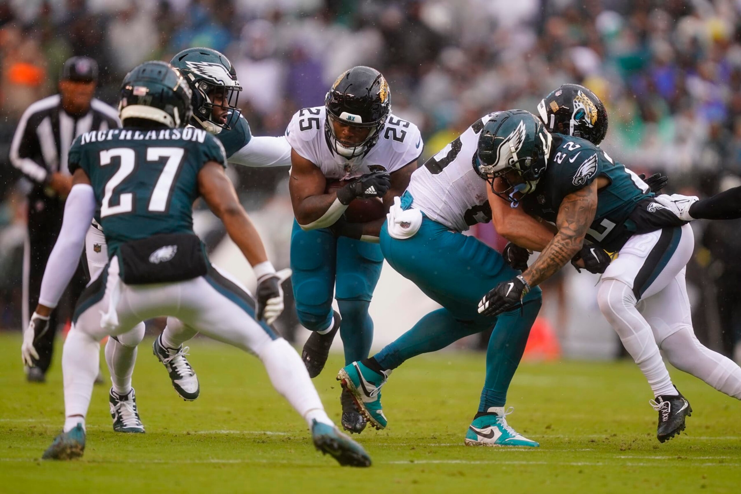 Jacksonville Jaguars' James Robinson, center, runs with the ball during the first half of an NFL football game against the Philadelphia Eagles on Sunday, Oct. 2, 2022, in Philadelphia. (AP Photo/Matt Rourke)
