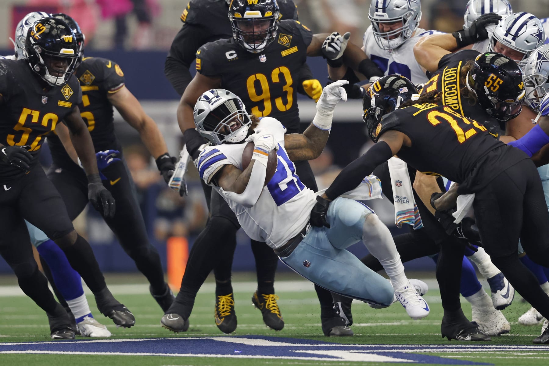 Dallas Cowboys running back Ezekiel Elliott (21) runs the ball past Washington Commanders safety Bobby McCain (20) during an NFL football game, Sunday, Oct. 2, 2022, in Arlington. (AP Photo/Tyler Kaufman)