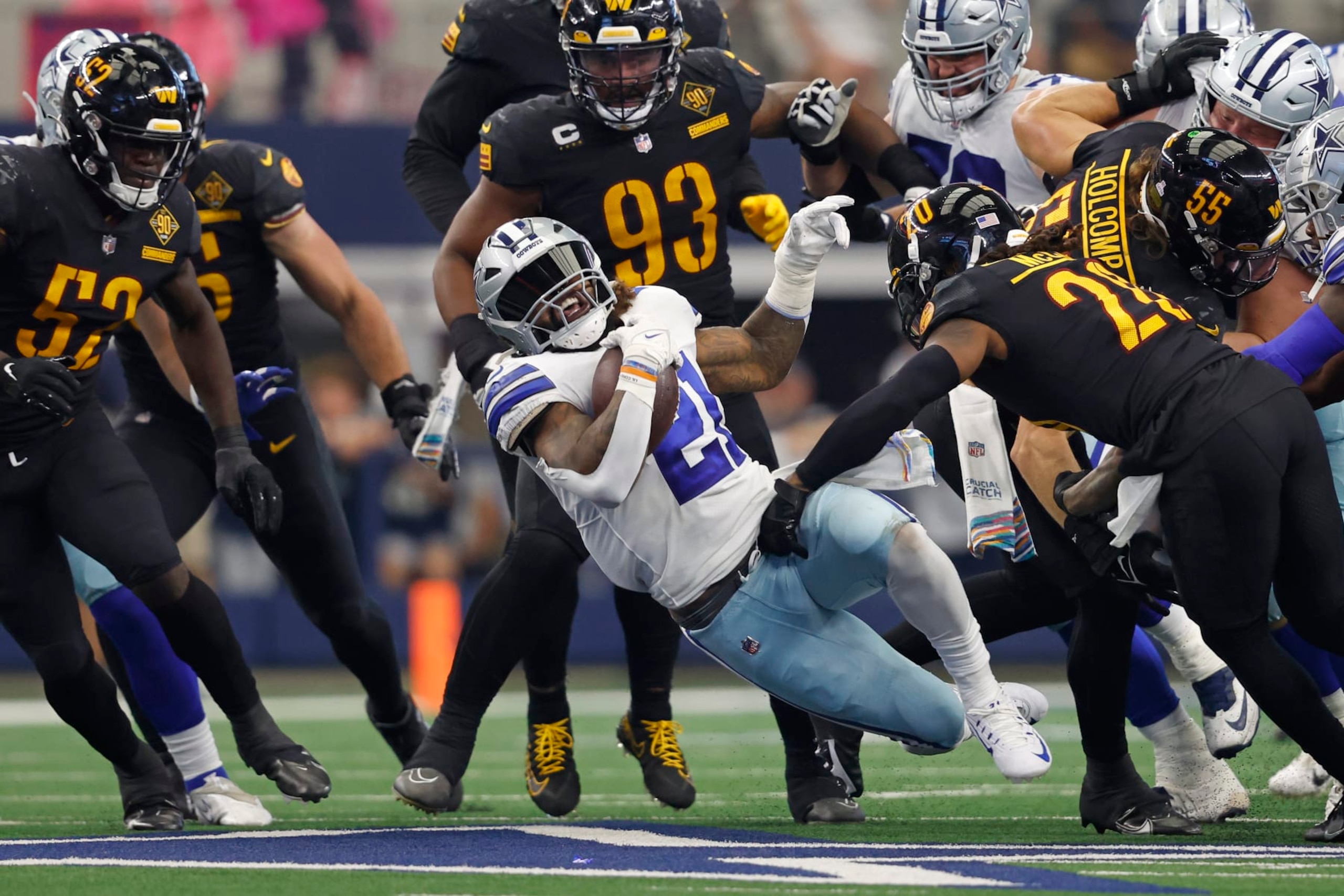 Dallas Cowboys running back Ezekiel Elliott (21) runs the ball past Washington Commanders safety Bobby McCain (20) during an NFL football game, Sunday, Oct. 2, 2022, in Arlington. (AP Photo/Tyler Kaufman)