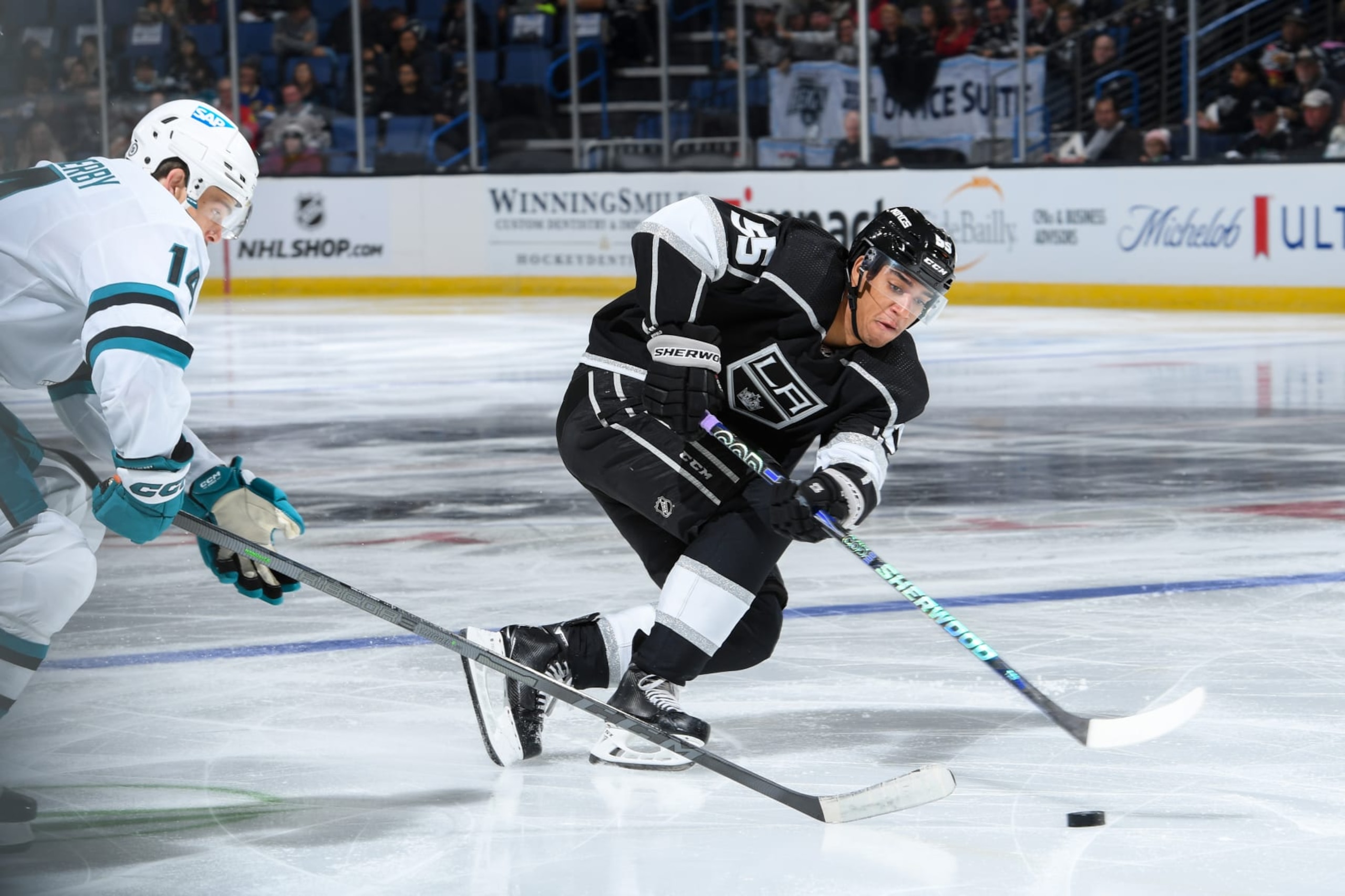 ONTARIO, CA - SEPTEMBER 28: Quinton Byfield #55 of the Los Angeles Kings passes the puck during the third period during the preseason game against the San Jose Sharks at Toyota Arena on September 28, 2022 in Ontario, California.  (Photo by Juan Ocampo/NHLI via Getty Images)