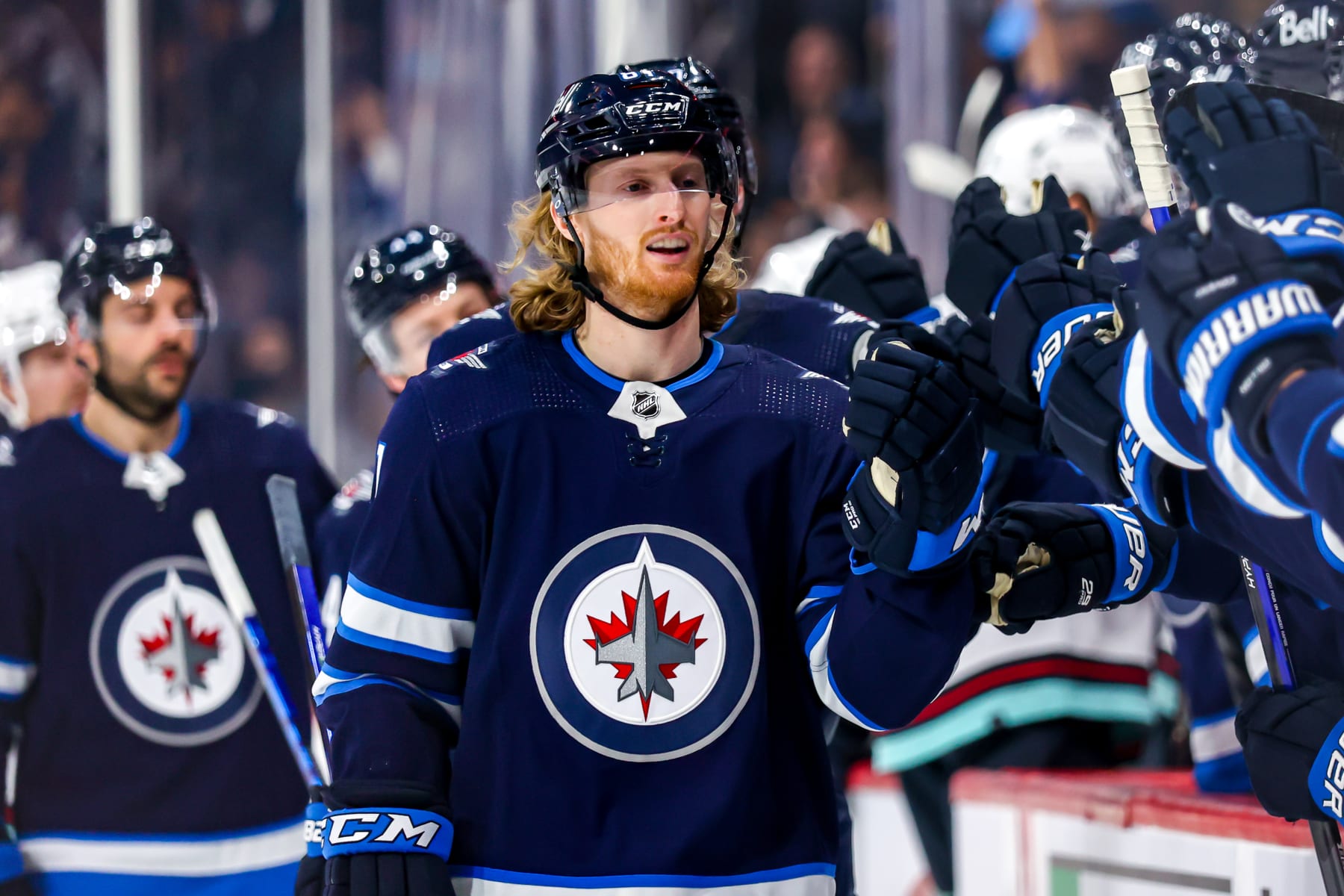 WINNIPEG, MB - MAY 01: Kyle Connor #81 of the Winnipeg Jets skates by the bench to celebrate his third period goal against the Seattle Kraken at Canada Life Centre on May 01, 2022 in Winnipeg, Manitoba, Canada. (Photo by Jonathan Kozub/NHLI via Getty Images)