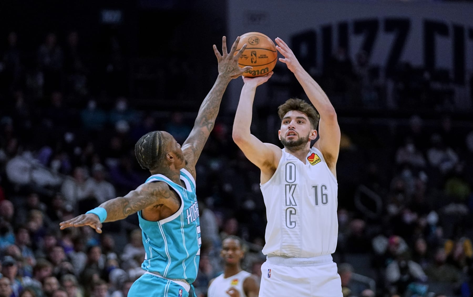 Oklahoma City Thunder guard Ty Jerome (16) shoots over Charlotte Hornets guard Terry Rozier during the second half of an NBA basketball game Friday, Jan. 21, 2022, in Charlotte, N.C. (AP Photo/Rusty Jones)