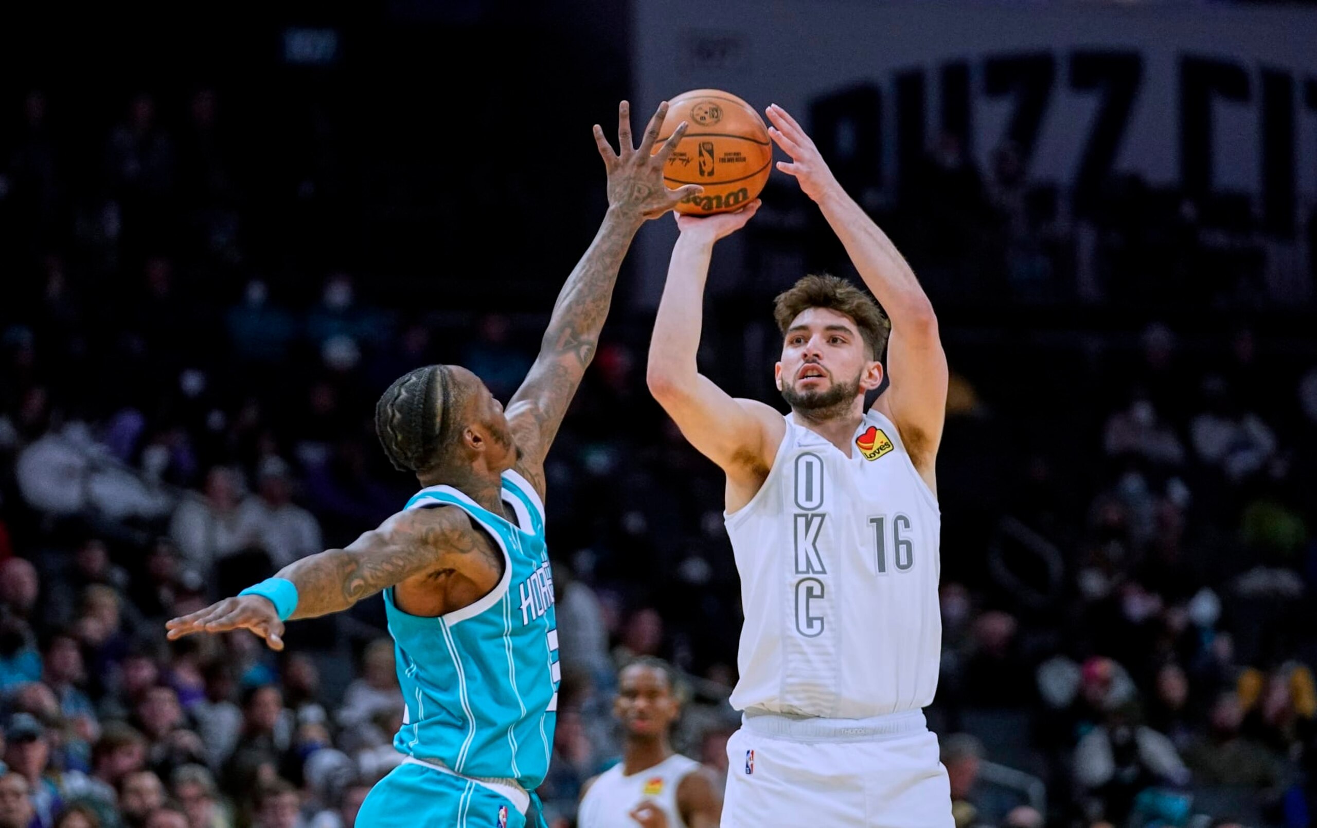 Oklahoma City Thunder guard Ty Jerome (16) shoots over Charlotte Hornets guard Terry Rozier during the second half of an NBA basketball game Friday, Jan. 21, 2022, in Charlotte, N.C. (AP Photo/Rusty Jones)