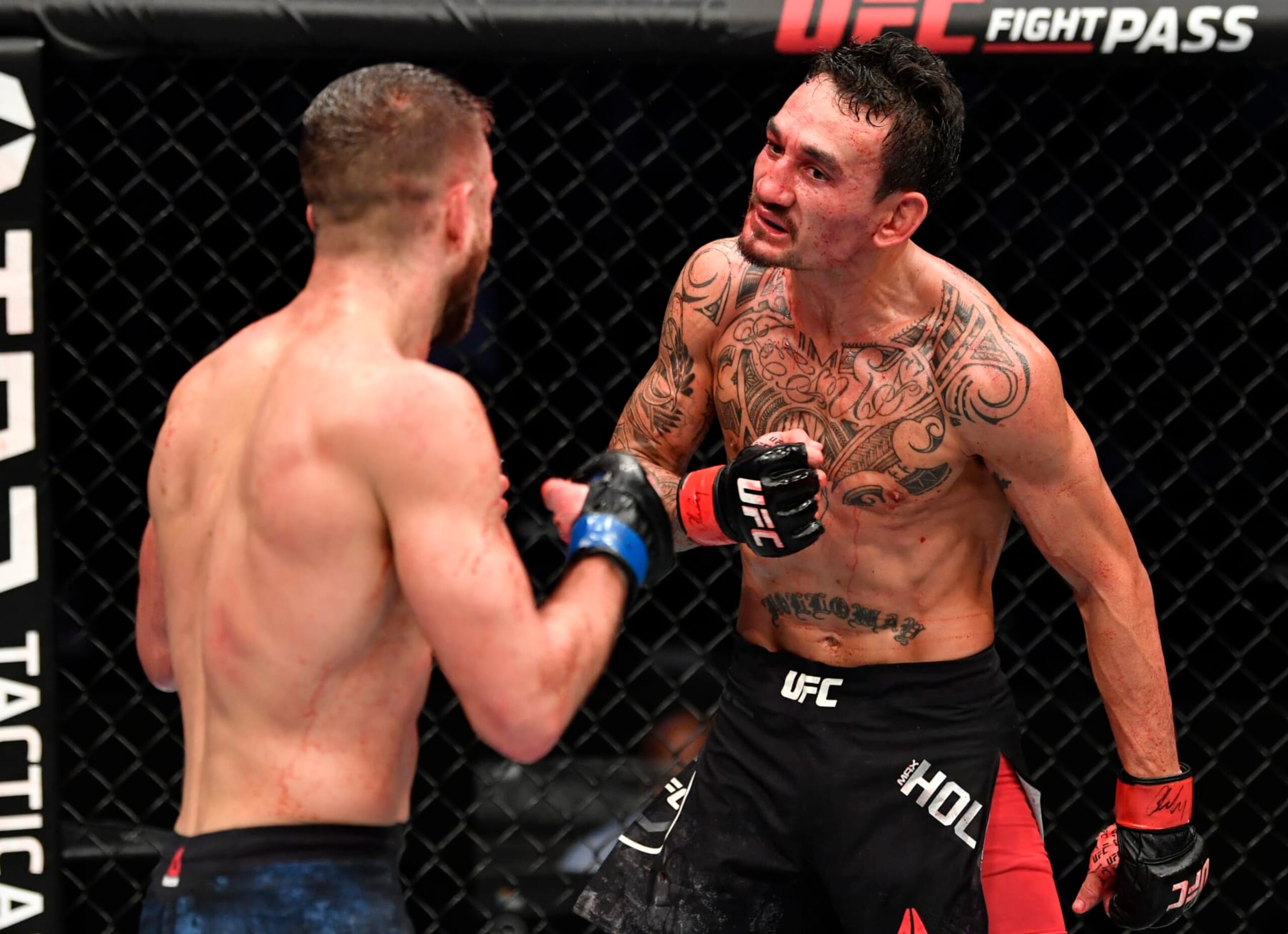 ABU DHABI, UNITED ARAB EMIRATES - JANUARY 17: (R-L) Max Holloway taunts Calvin Kattar in a featherweight bout during the UFC Fight Night event at Etihad Arena on UFC Fight Island on January 17, 2021 in Abu Dhabi, United Arab Emirates. (Photo by Jeff Bottari/Zuffa LLC) ABU DHABI, UNITED ARAB EMIRATES - JANUARY 17: (R-L) Max Holloway taunts Calvin Kattar in a featherweight bout during the UFC Fight Night event at Etihad Arena on UFC Fight Island on January 17, 2021 in Abu Dhabi, United Arab Emirates. (Photo by Jeff Bottari/Zuffa LLC)