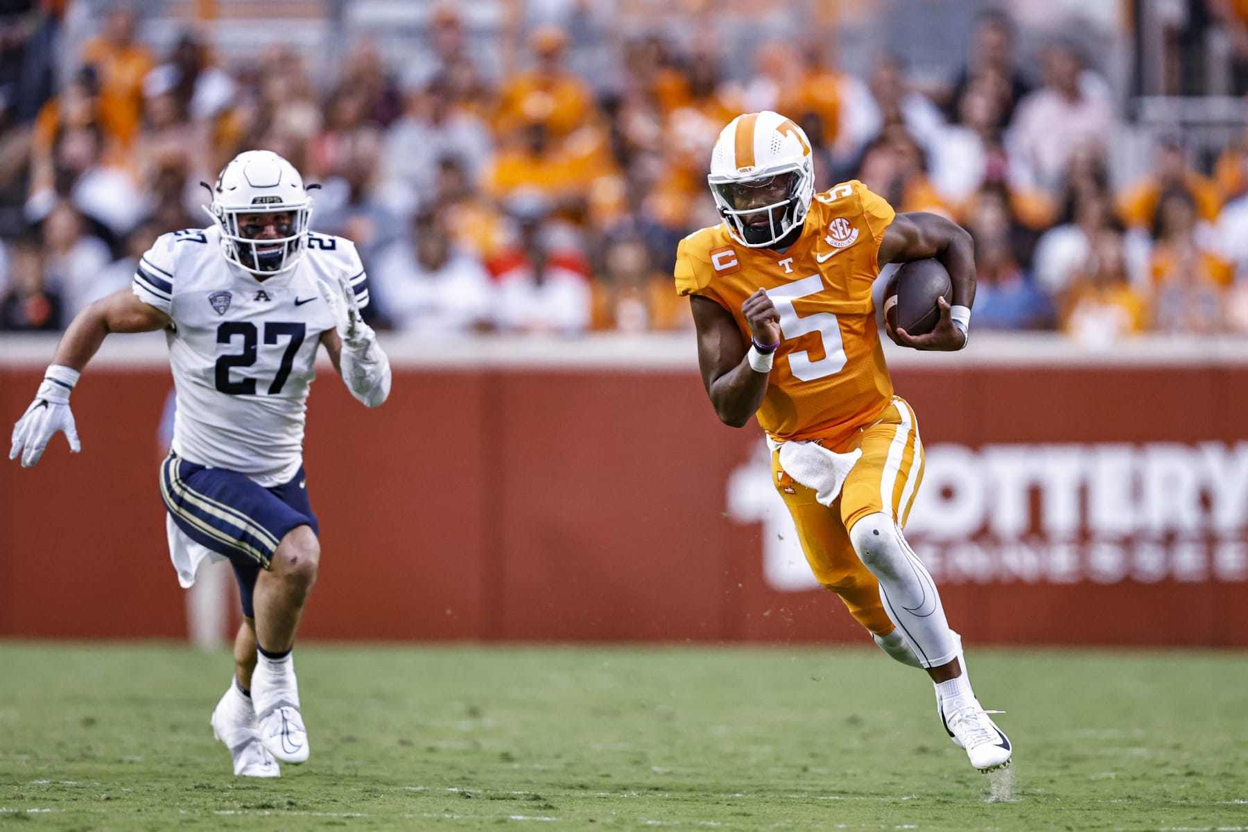 Tennessee quarterback Hendon Hooker (5) runs for yardage as he's chased by Akron linebacker Bubba Arslanian (27) during the first half of an NCAA college football game, Saturday, Sept. 17, 2022, in Knoxville, Tenn. (AP Photo/Wade Payne)