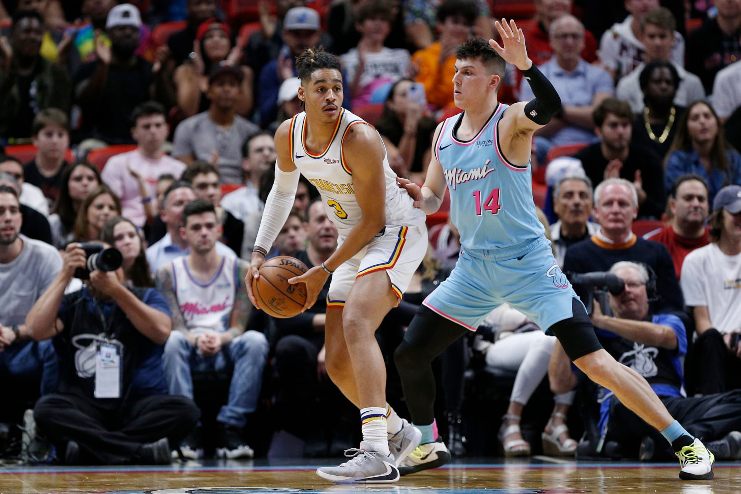 MIAMI, FLORIDA - NOVEMBER 29:  Jordan Poole #3 of the Golden State Warriors is guarded by Tyler Herro #14 of the Miami Heat during the second half at American Airlines Arena on November 29, 2019 in Miami, Florida. NOTE TO USER: User expressly acknowledges and agrees that, by downloading and/or using this photograph, user is consenting to the terms and conditions of the Getty Images License Agreement. (Photo by Michael Reaves/Getty Images)