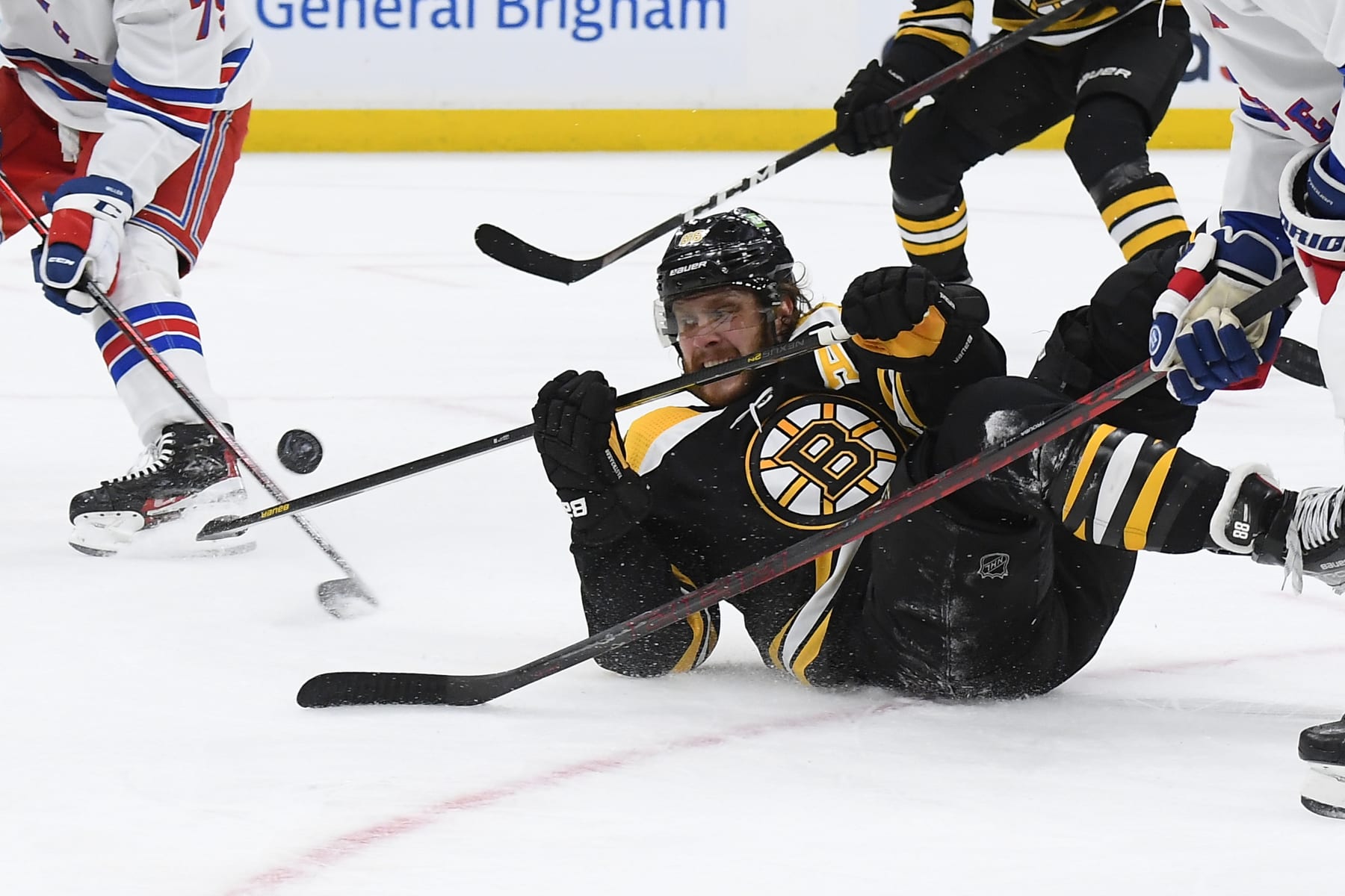 BOSTON, MA - APRIL 23:  David Pastrnak #88 of the Boston Bruins fights for the puck against the New York Rangers at the TD Garden on April 23, 2022 in Boston, Massachusetts. (Photo by Brian Babineau/NHLI via Getty Images)