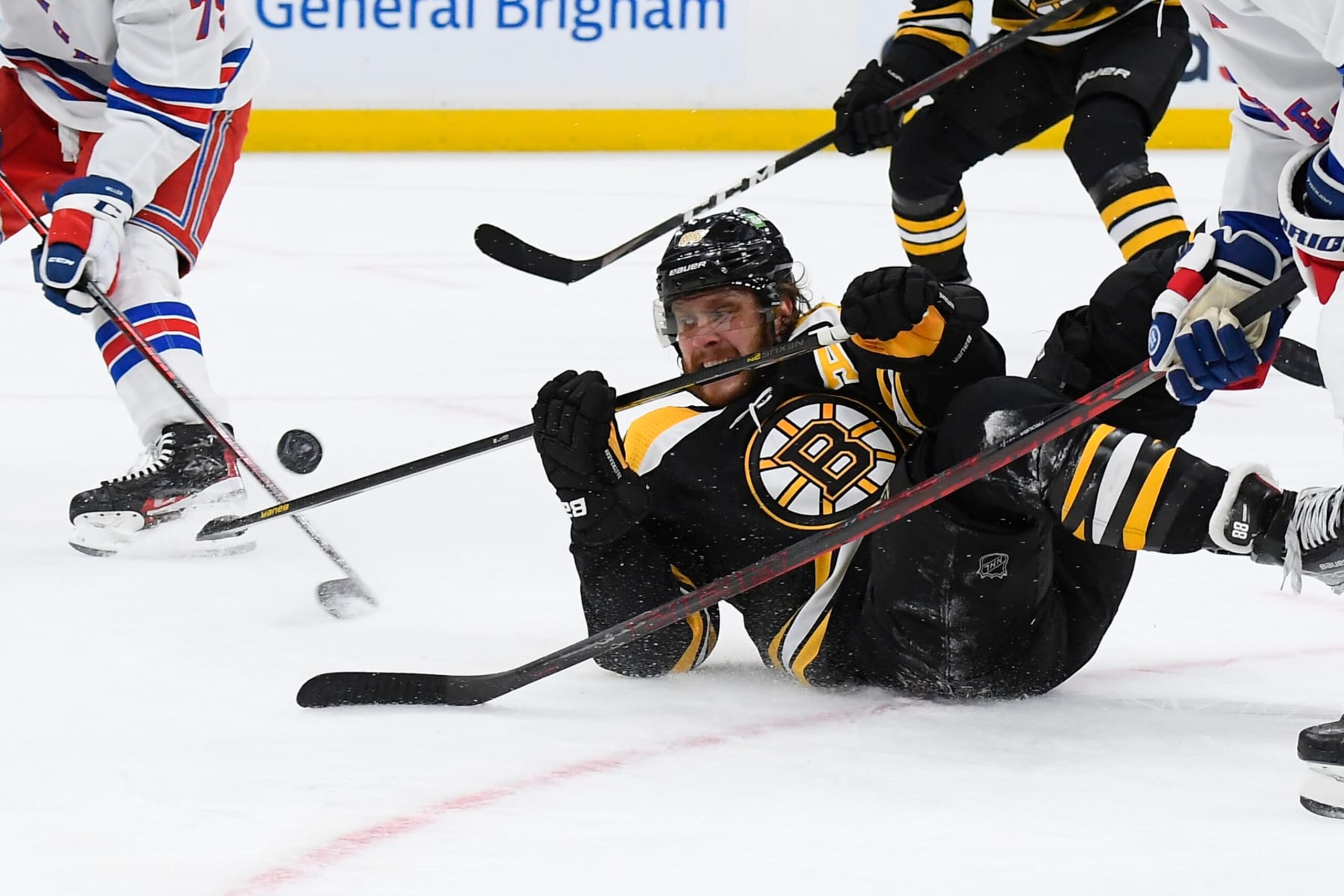 BOSTON, MA - APRIL 23:  David Pastrnak #88 of the Boston Bruins fights for the puck against the New York Rangers at the TD Garden on April 23, 2022 in Boston, Massachusetts. (Photo by Brian Babineau/NHLI via Getty Images)