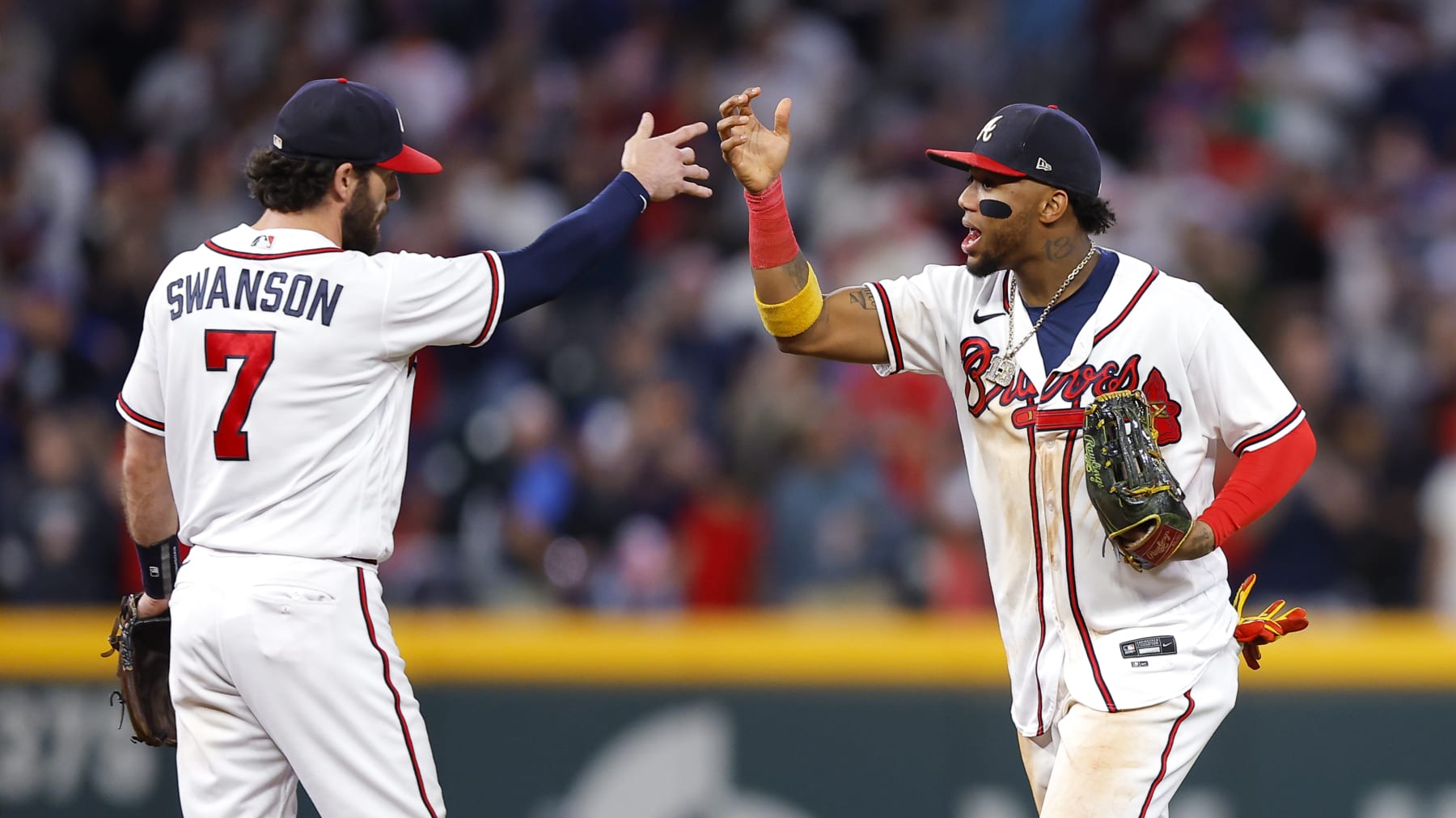 ATLANTA, GA - OCTOBER 01: Dansby Swanson #7 and Ronald Acuna Jr. #13 of the Atlanta Braves celebrate the 4-2 victory over the New York Mets at Truist Park on October 1, 2022 in Atlanta, Georgia. (Photo by Todd Kirkland/Getty Images)