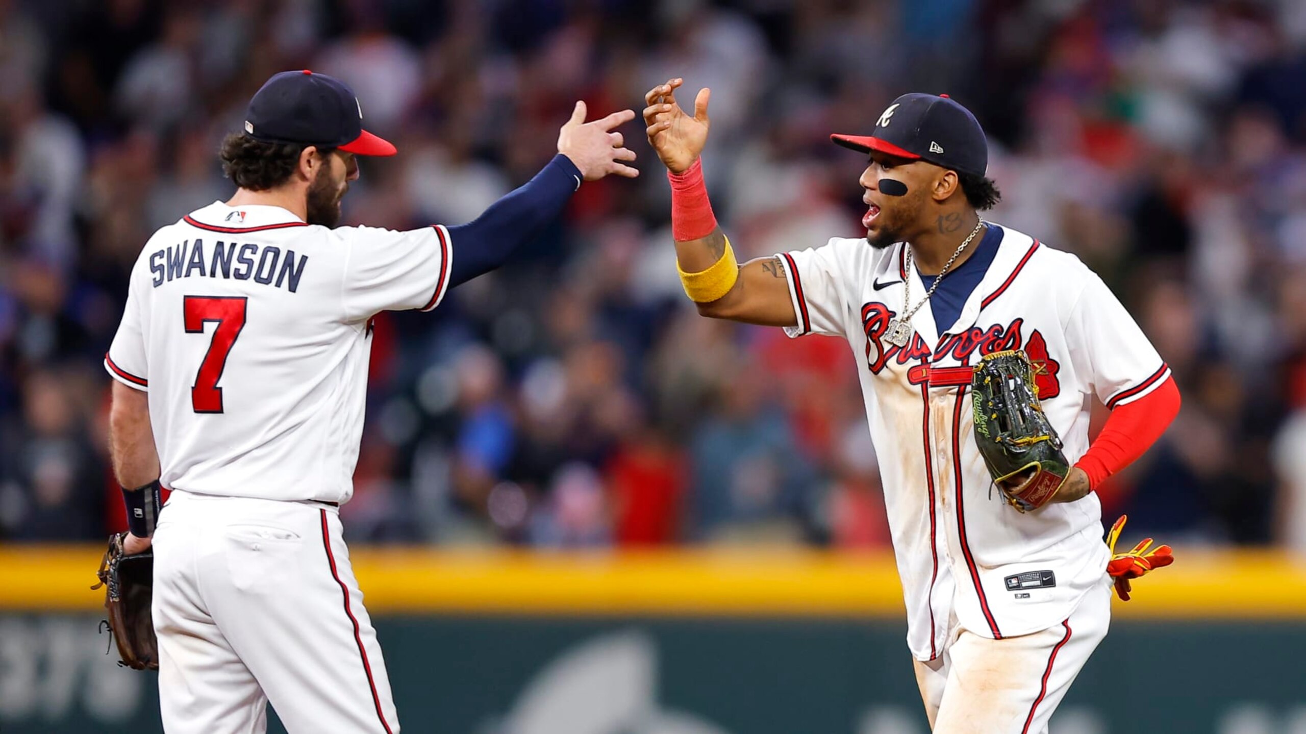 ATLANTA, GA - OCTOBER 01: Dansby Swanson #7 and Ronald Acuna Jr. #13 of the Atlanta Braves celebrate the 4-2 victory over the New York Mets at Truist Park on October 1, 2022 in Atlanta, Georgia. (Photo by Todd Kirkland/Getty Images)