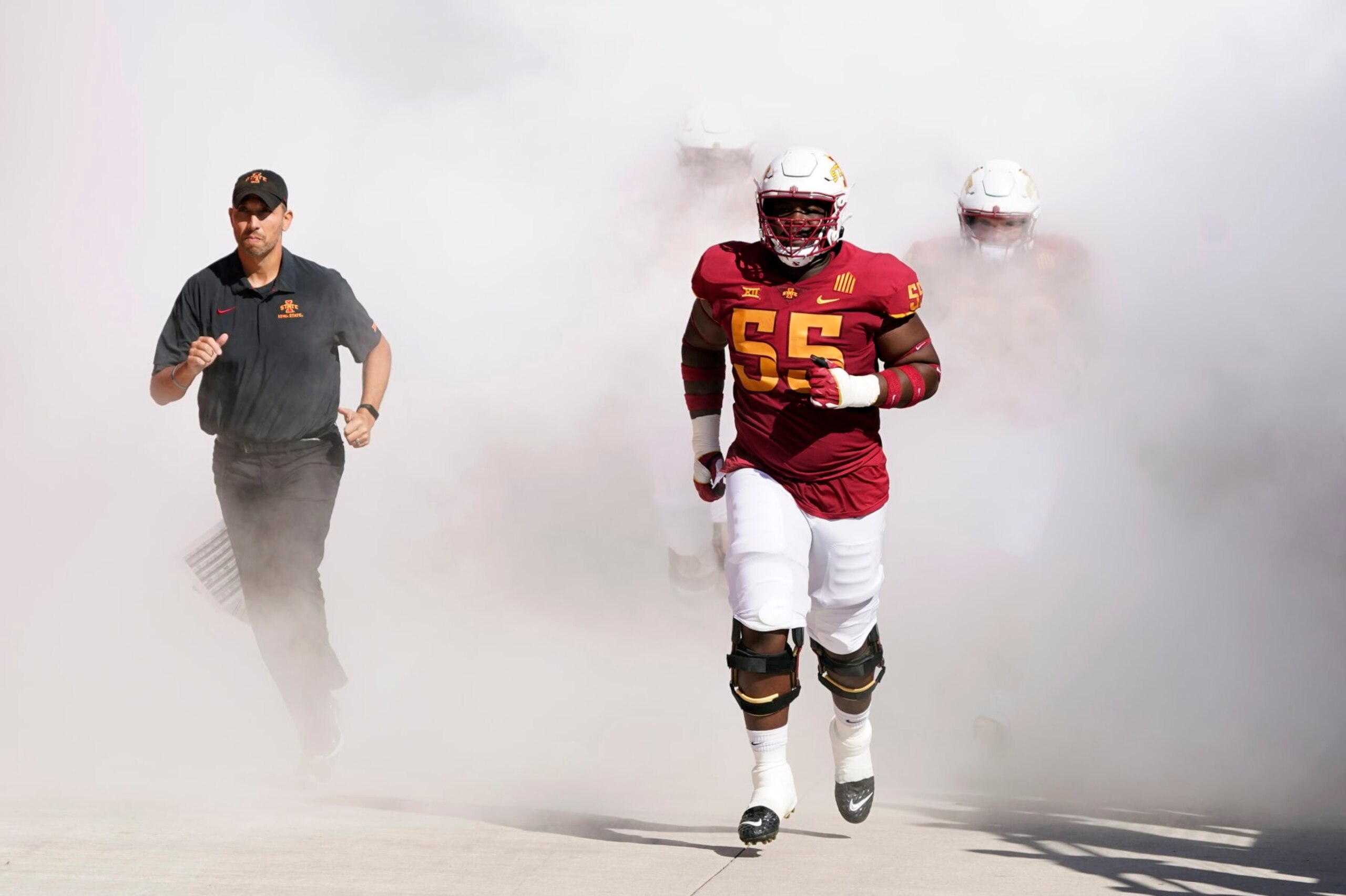 Iowa State head coach Matt Campbell, left, and offensive lineman Darrell Simmons Jr. (55) run onto the field before an NCAA college football game against Baylor, Saturday, Sept. 24, 2022, in Ames, Iowa. (AP Photo/Charlie Neibergall) Iowa State head coach Matt Campbell, left, and offensive lineman Darrell Simmons Jr. (55) run onto the field before an NCAA college football game against Baylor, Saturday, Sept. 24, 2022, in Ames, Iowa. (AP Photo/Charlie Neibergall)